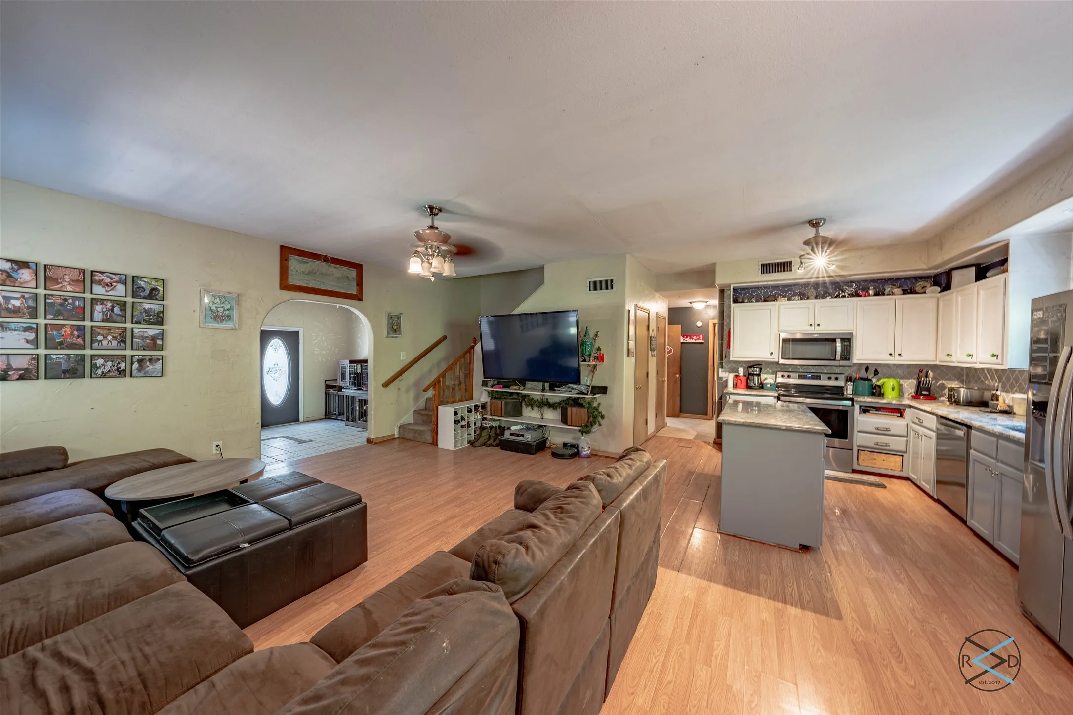 Living room featuring light wood-type flooring and ceiling fan