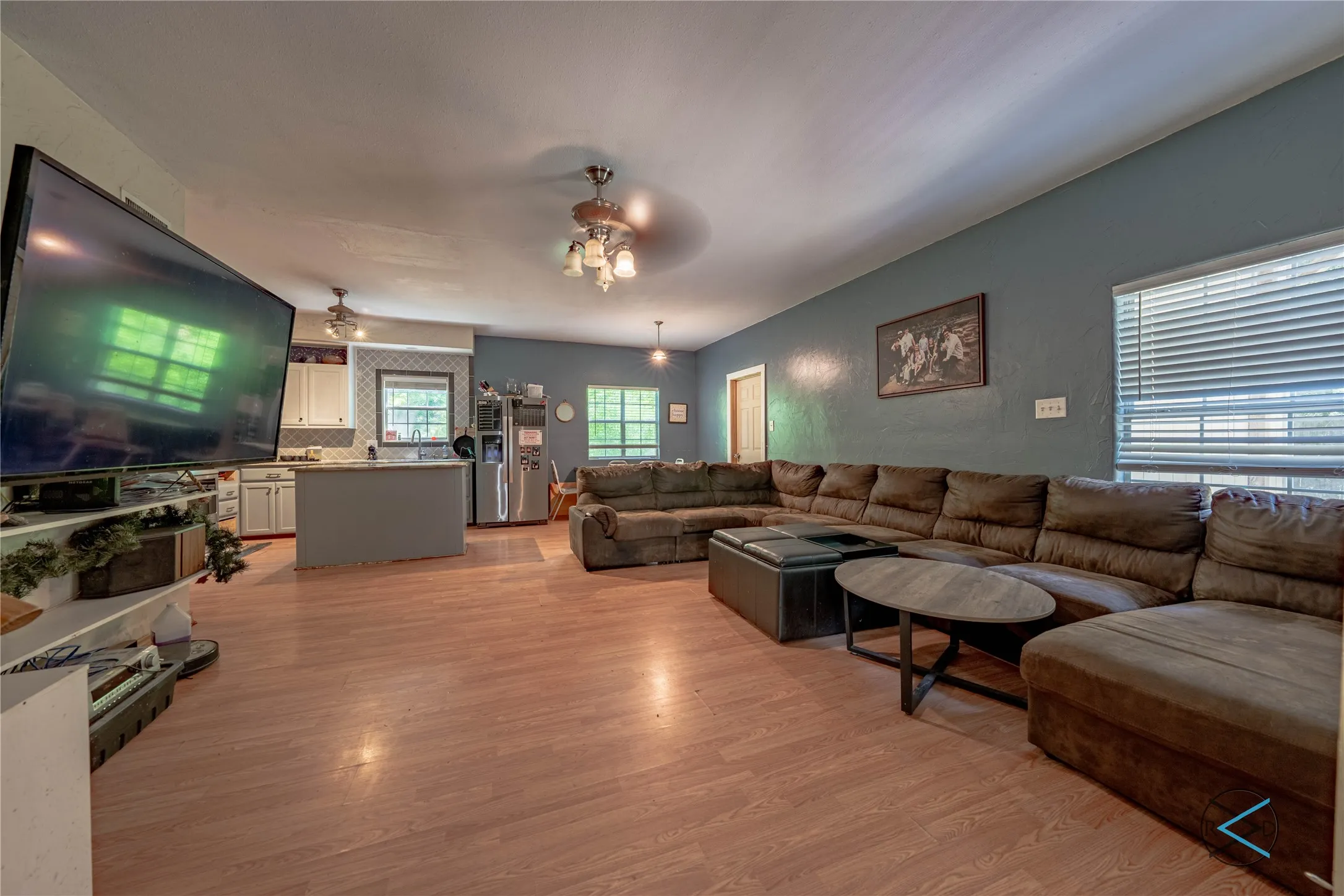 Living room featuring light hardwood / wood-style floors and ceiling fan