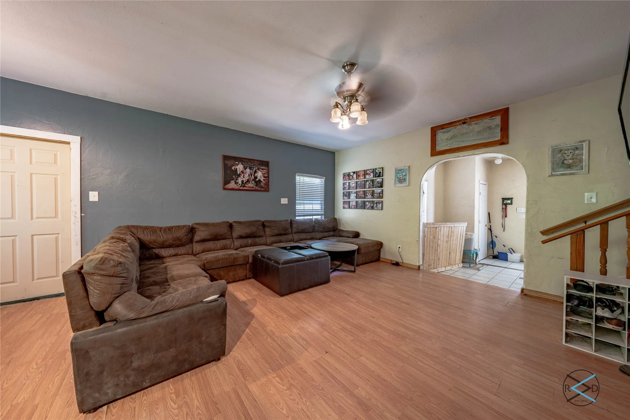 Living room featuring light hardwood / wood-style floors and ceiling fan