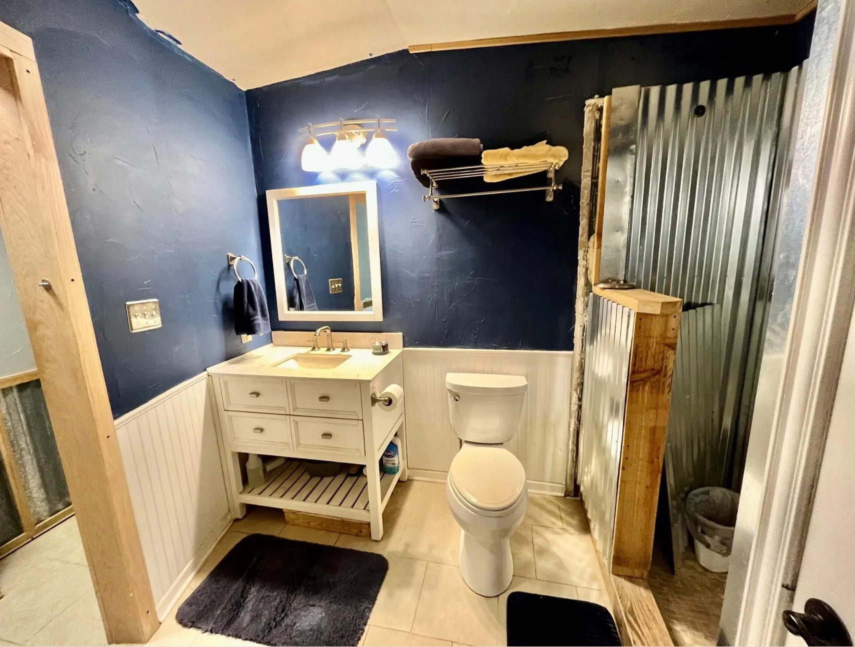 Bathroom featuring vanity, tile patterned floors, and toilet