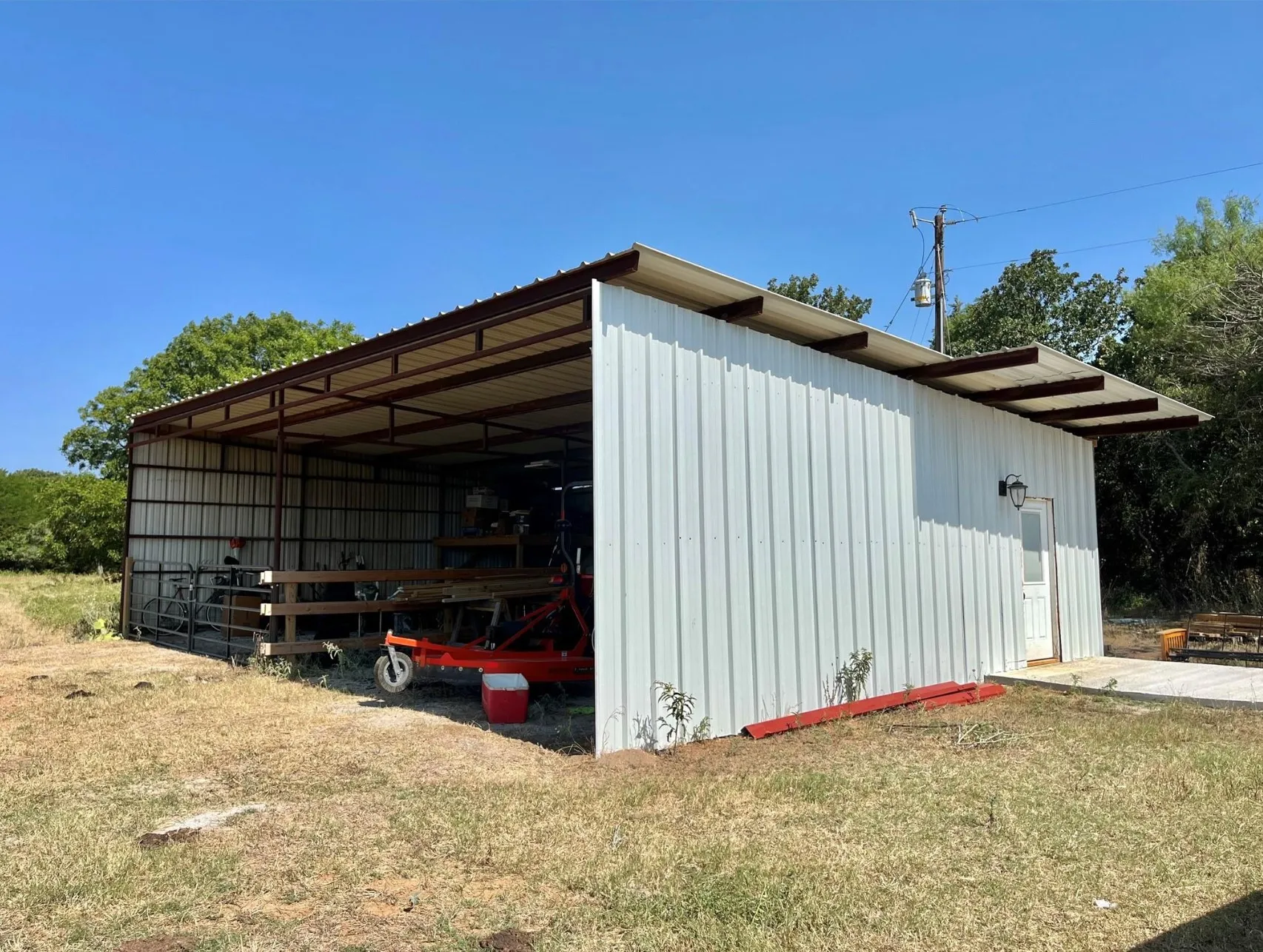 View of outdoor structure featuring a yard