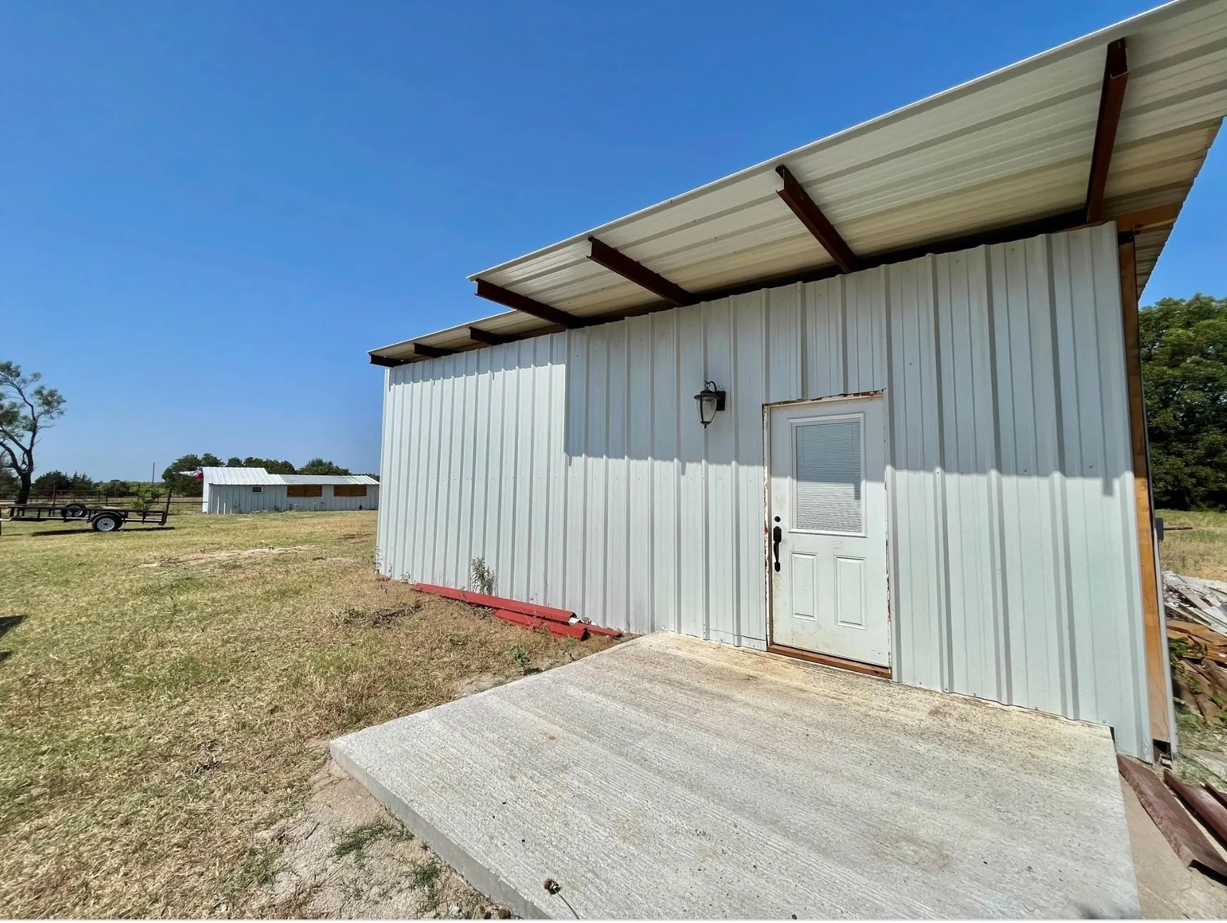 View of outbuilding with a lawn
