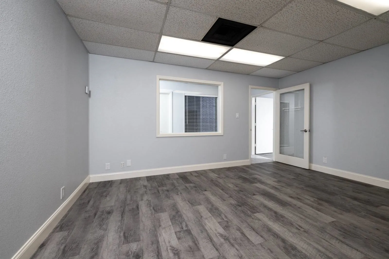 Spare room with wood-type flooring and a paneled ceiling