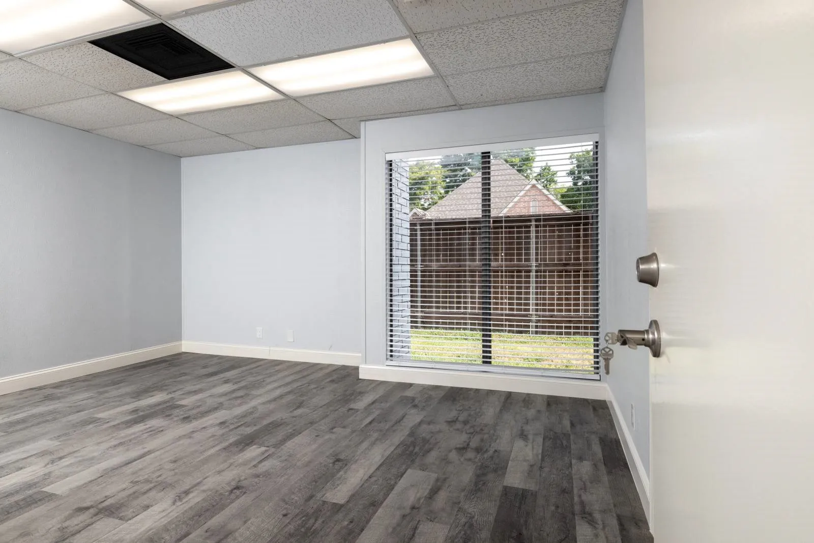 Unfurnished room with plenty of natural light, a paneled ceiling, and wood-type flooring
