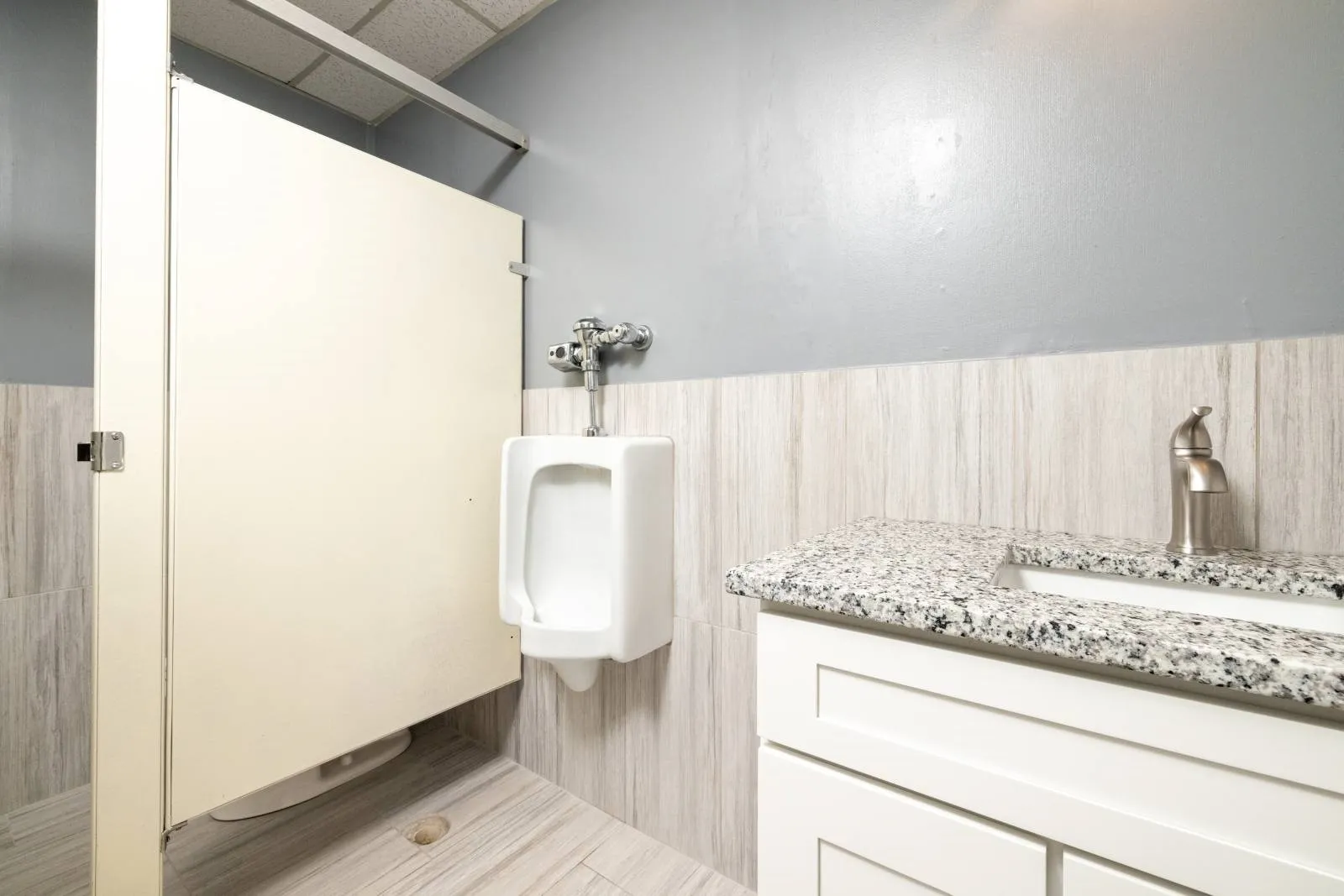 Bathroom with vanity and tile walls