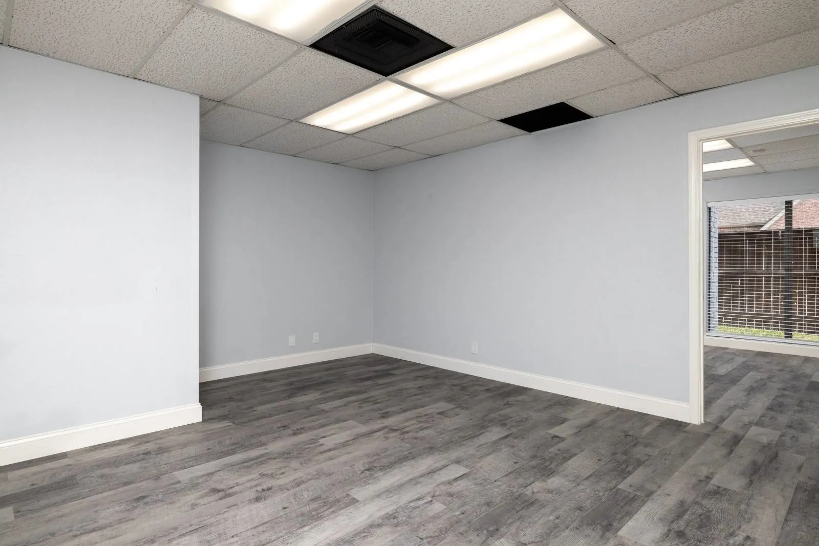 Spare room featuring hardwood / wood-style floors and a paneled ceiling