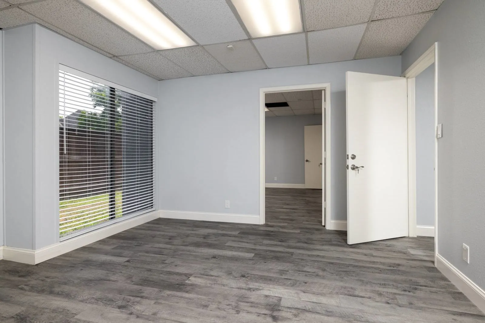 Spare room with hardwood / wood-style flooring and a paneled ceiling