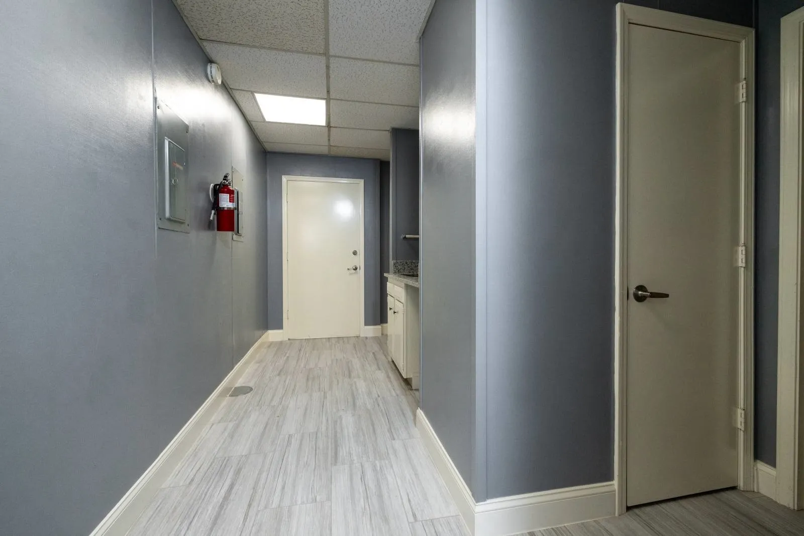 Hall featuring a paneled ceiling