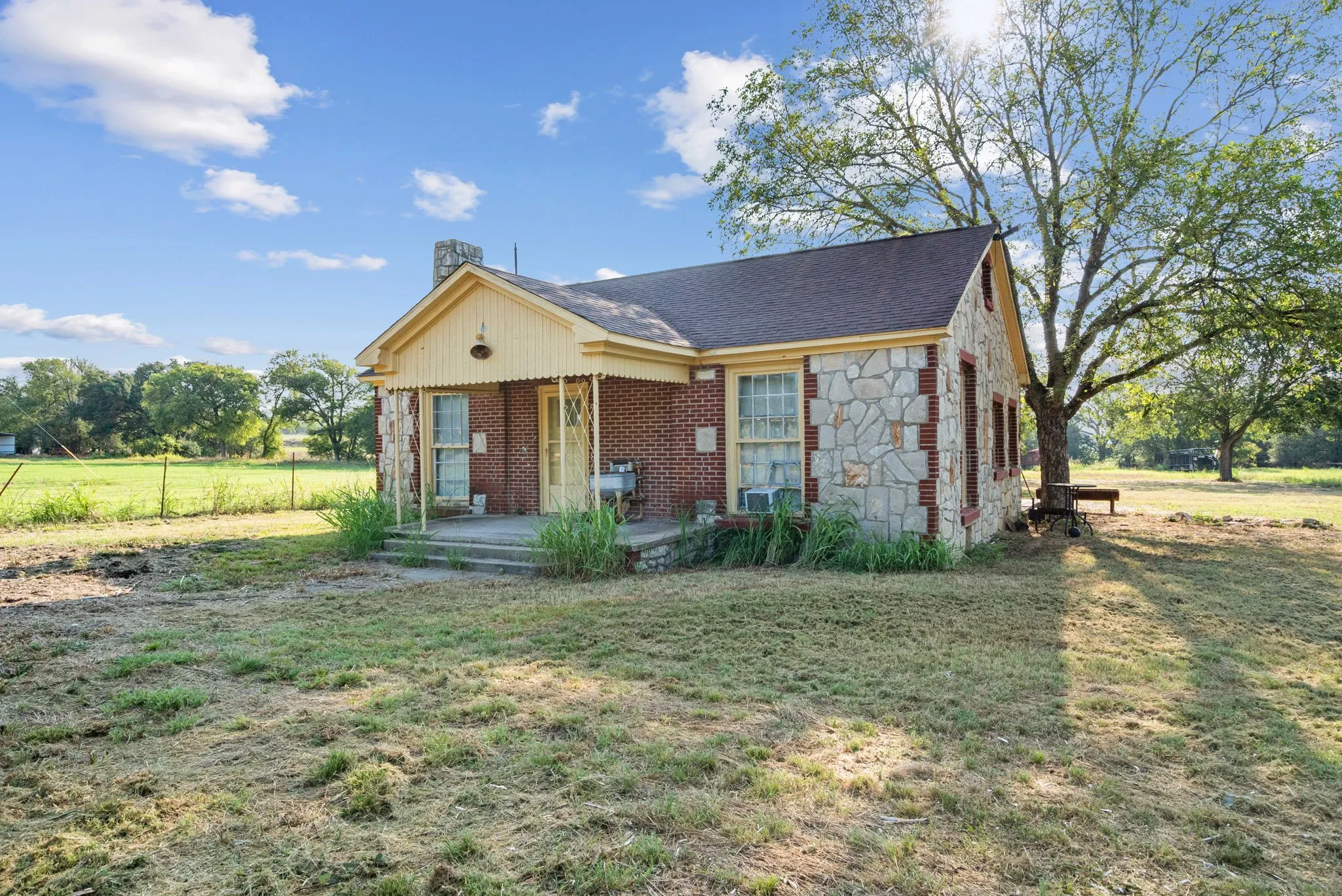View of front of property featuring covered porch and a front yard
