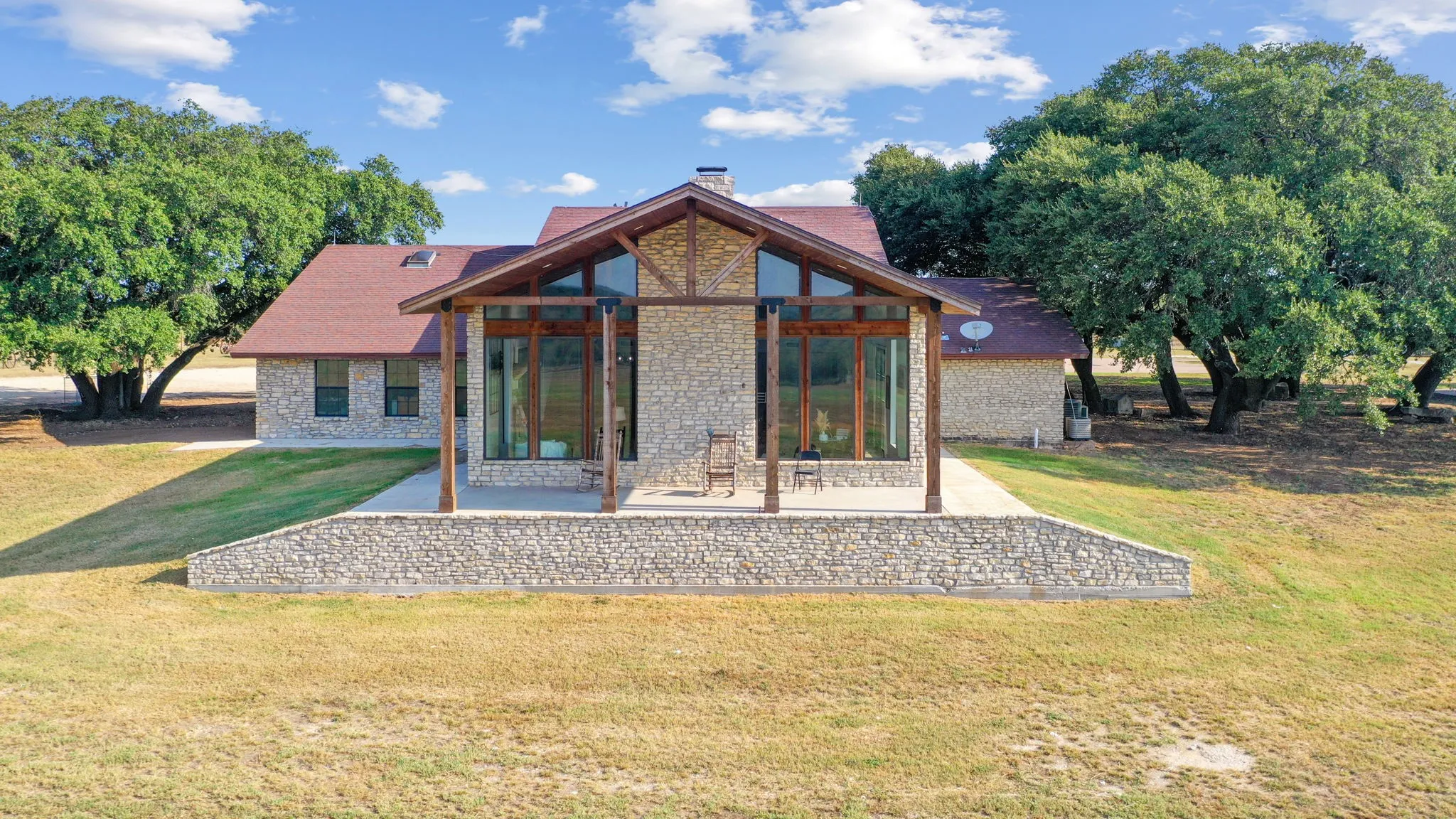 Rear view of property with a patio and a yard