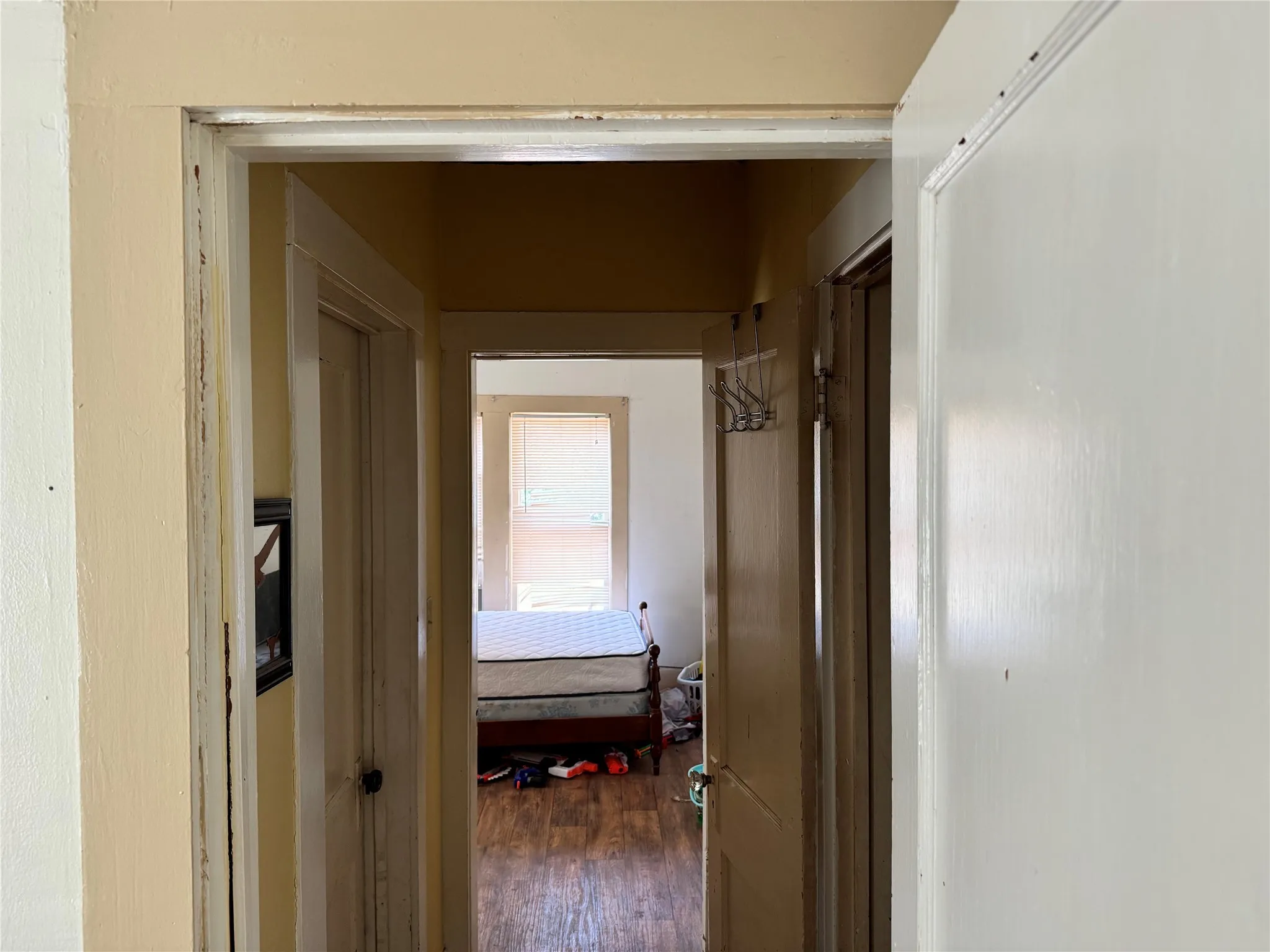 Corridor with hardwood / wood-style floors