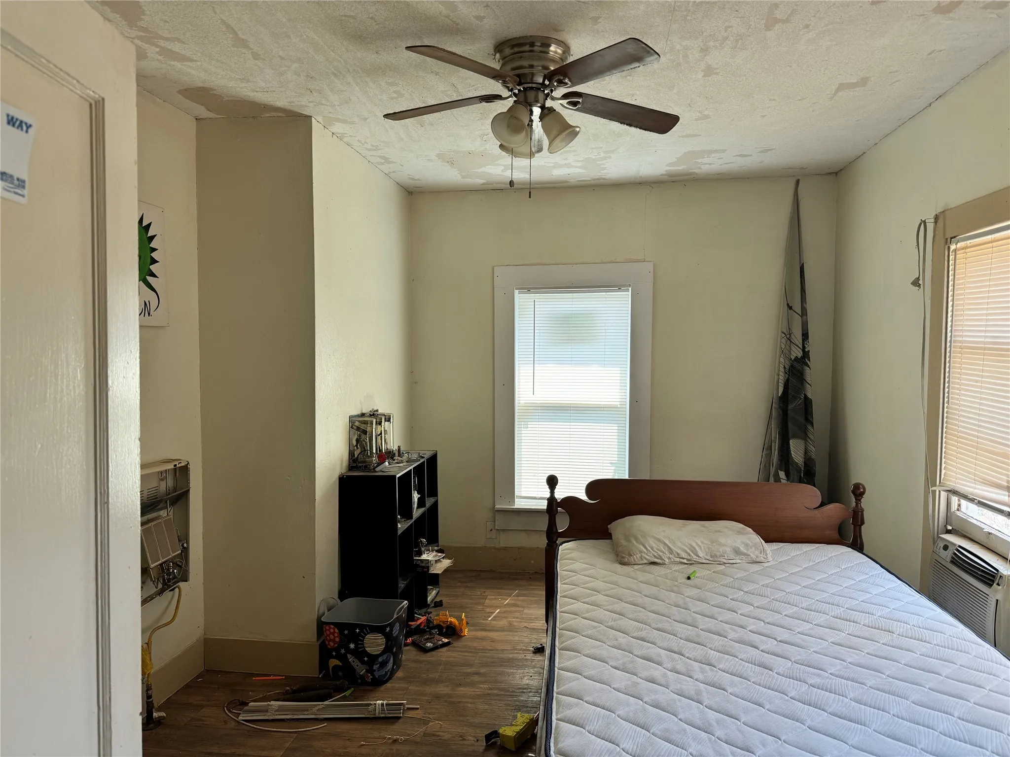 Bedroom featuring multiple windows, hardwood / wood-style floors, and ceiling fan