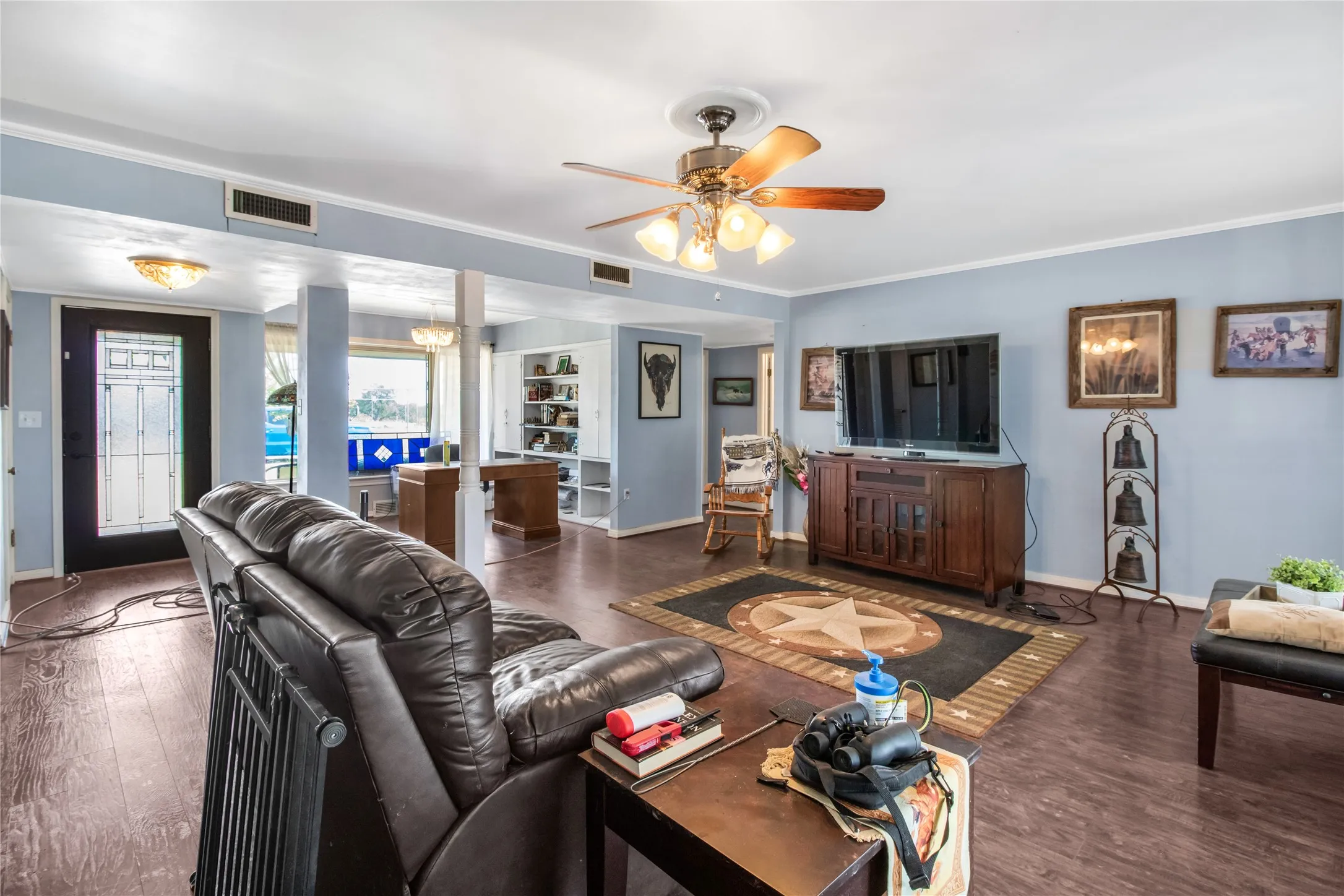 Living room with ceiling fan, ornamental molding, and hardwood / wood-style flooring