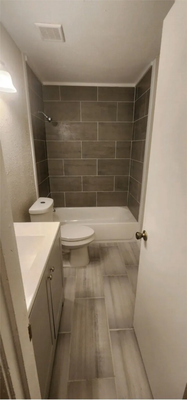Bathroom with tile patterned floors, vanity, and toilet