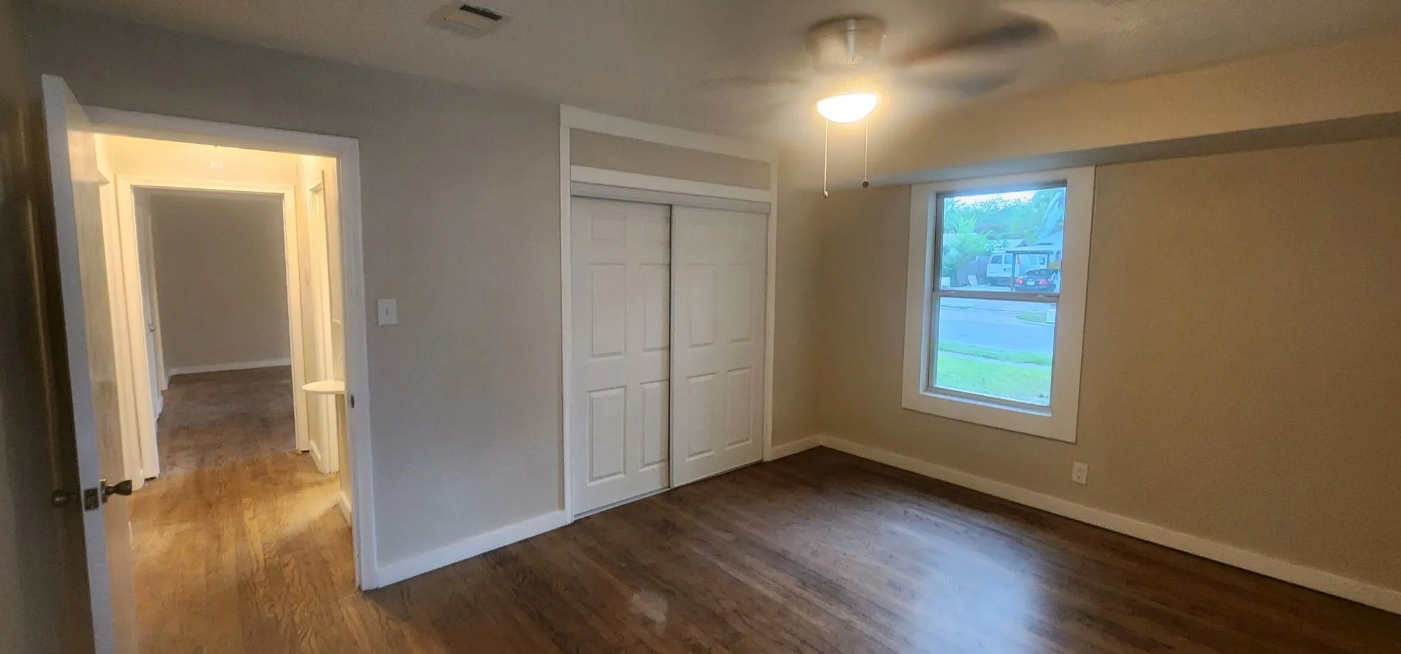 Unfurnished bedroom featuring a closet, hardwood / wood-style flooring, and ceiling fan