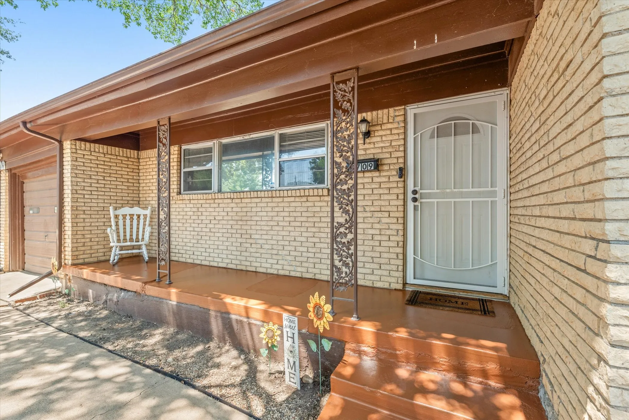 Beautiful freshly painted front porch. Flower bed is ready for your choice of arrangement