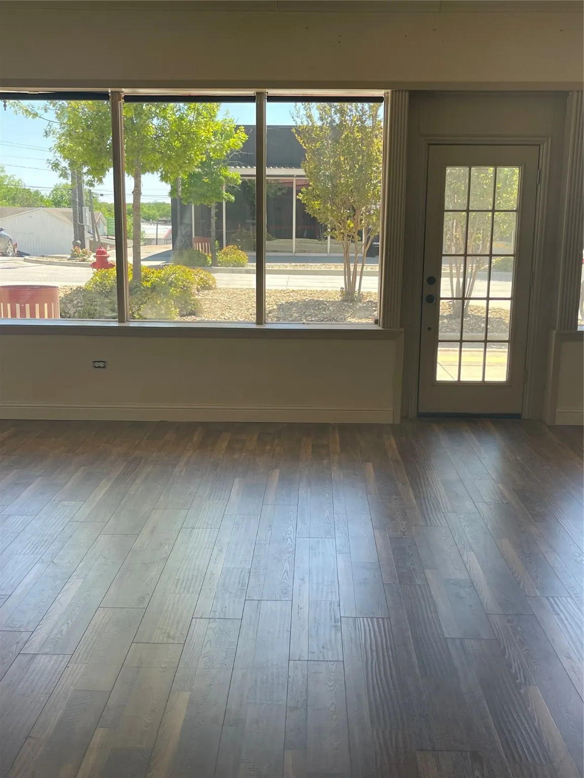 Spare room with dark hardwood / wood-style flooring and plenty of natural light