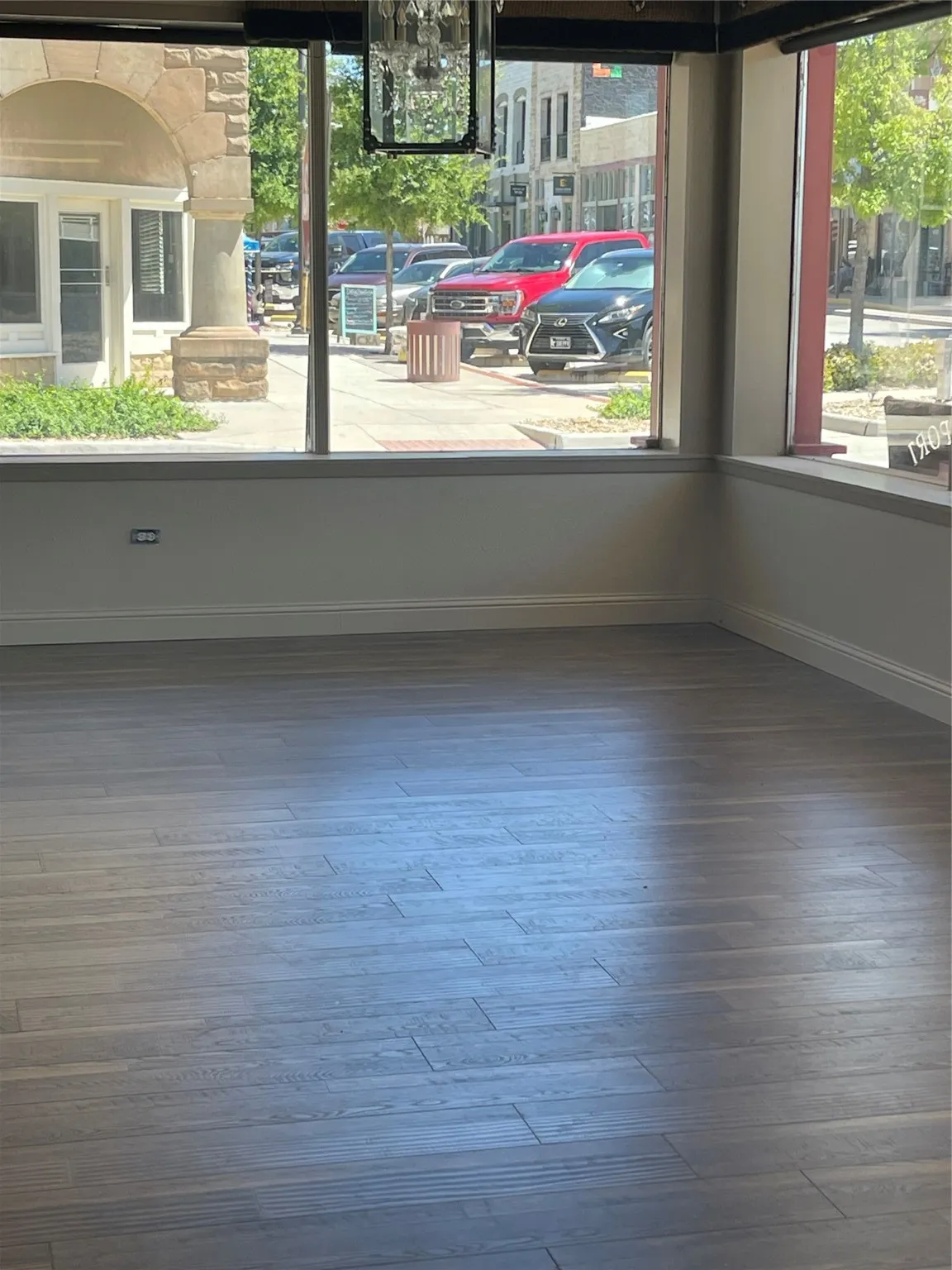 Empty room with hardwood / wood-style floors and plenty of natural light