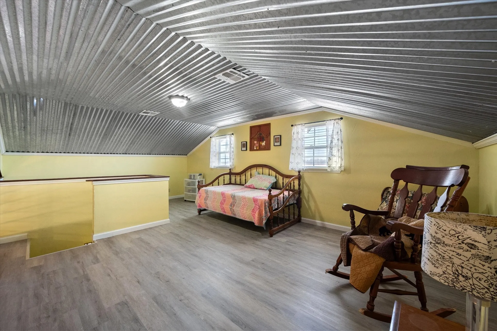 Bedroom with lofted ceiling and hardwood / wood-style floors