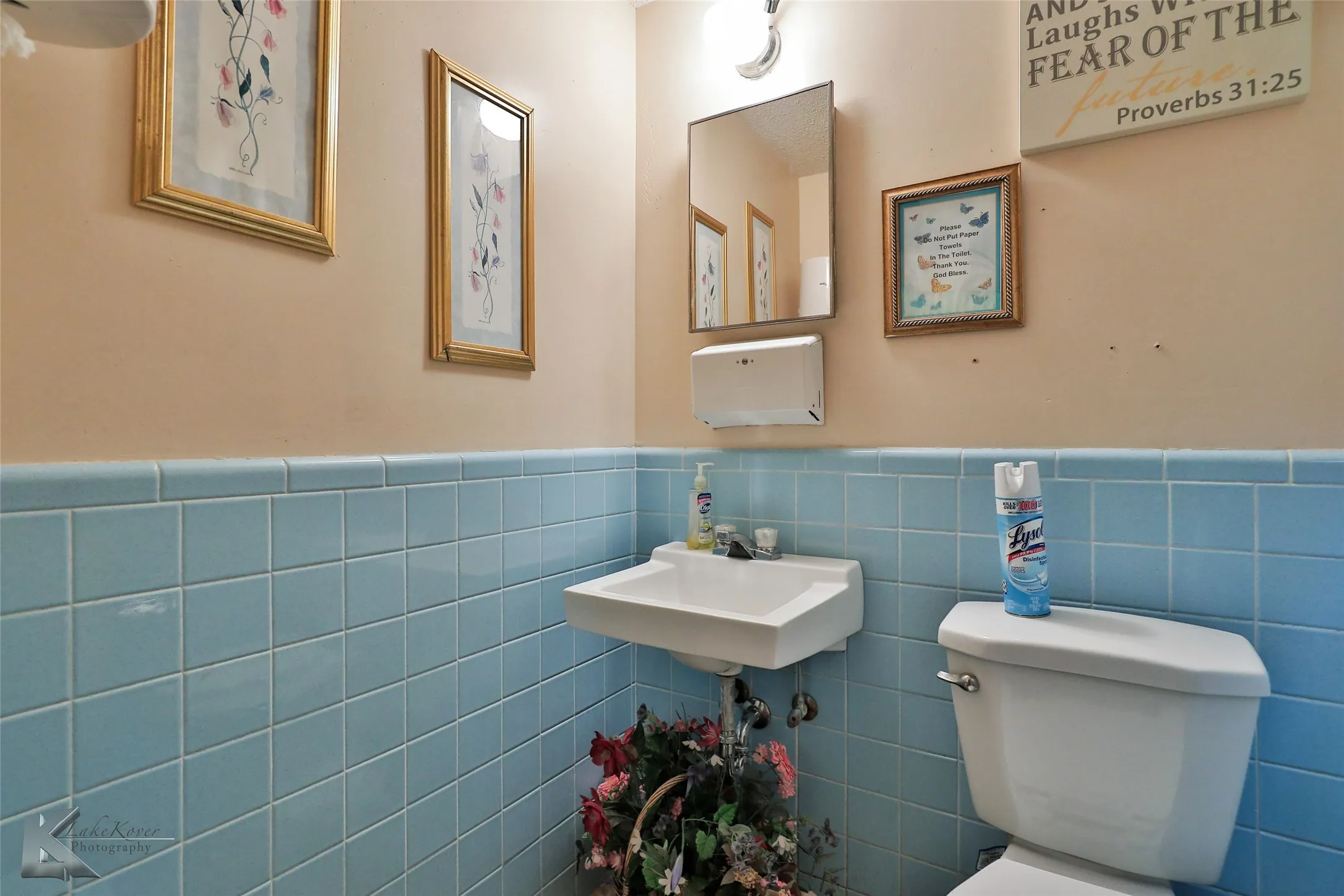 Bathroom with sink, tile walls, toilet, and backsplash