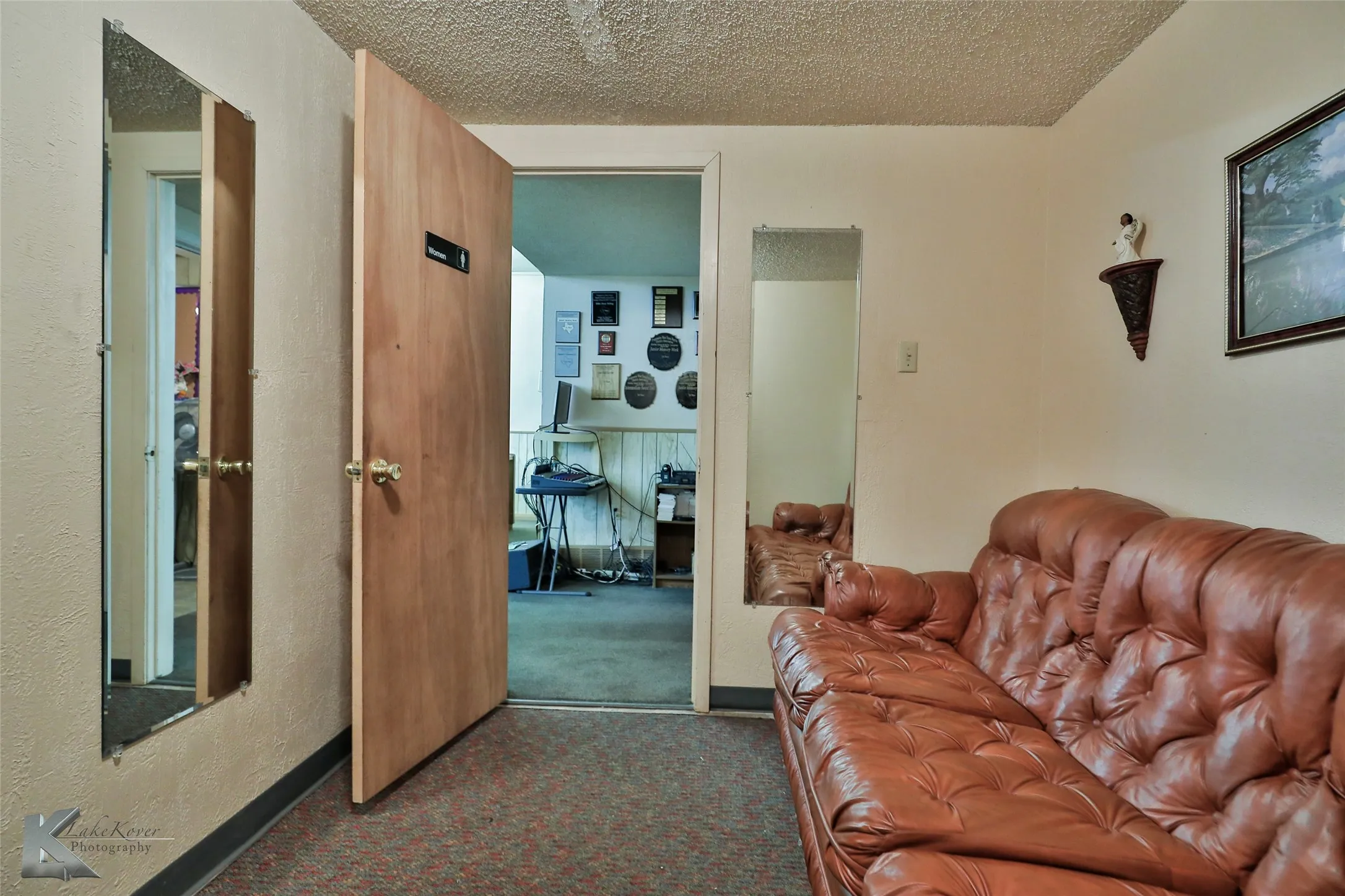 Living room with a textured ceiling and carpet flooring