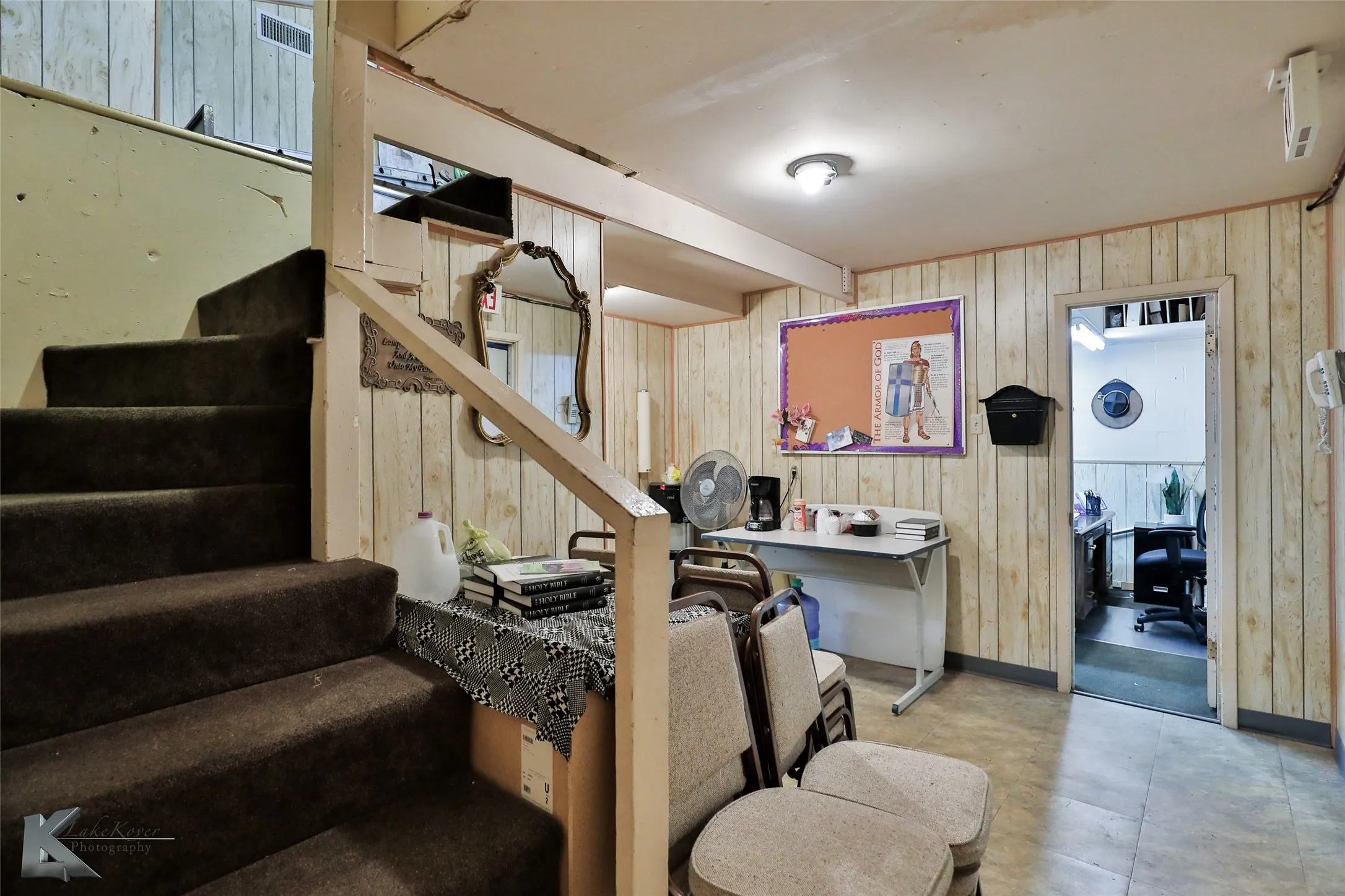 Stairway featuring tile patterned flooring and wooden walls