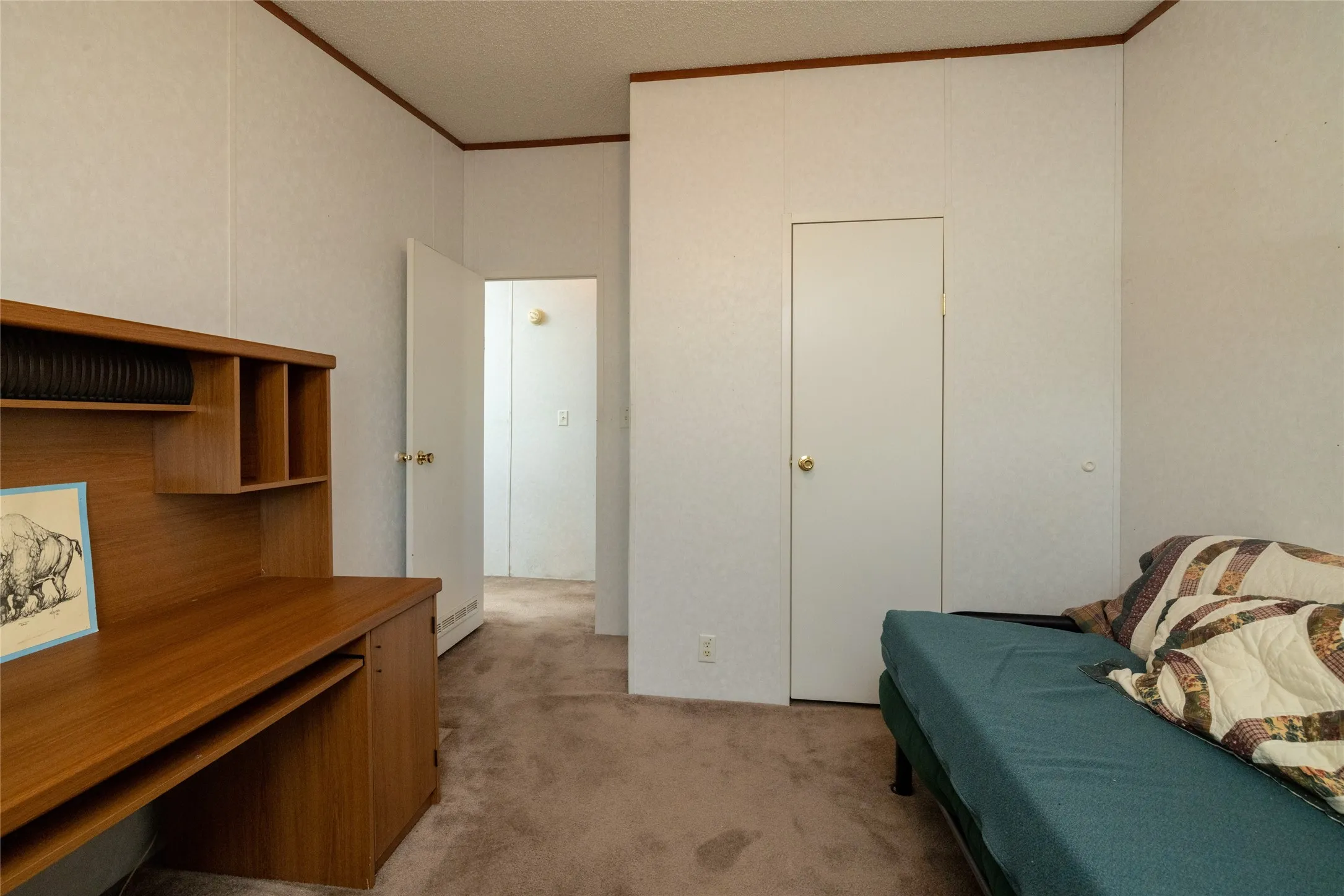 Carpeted bedroom featuring crown molding