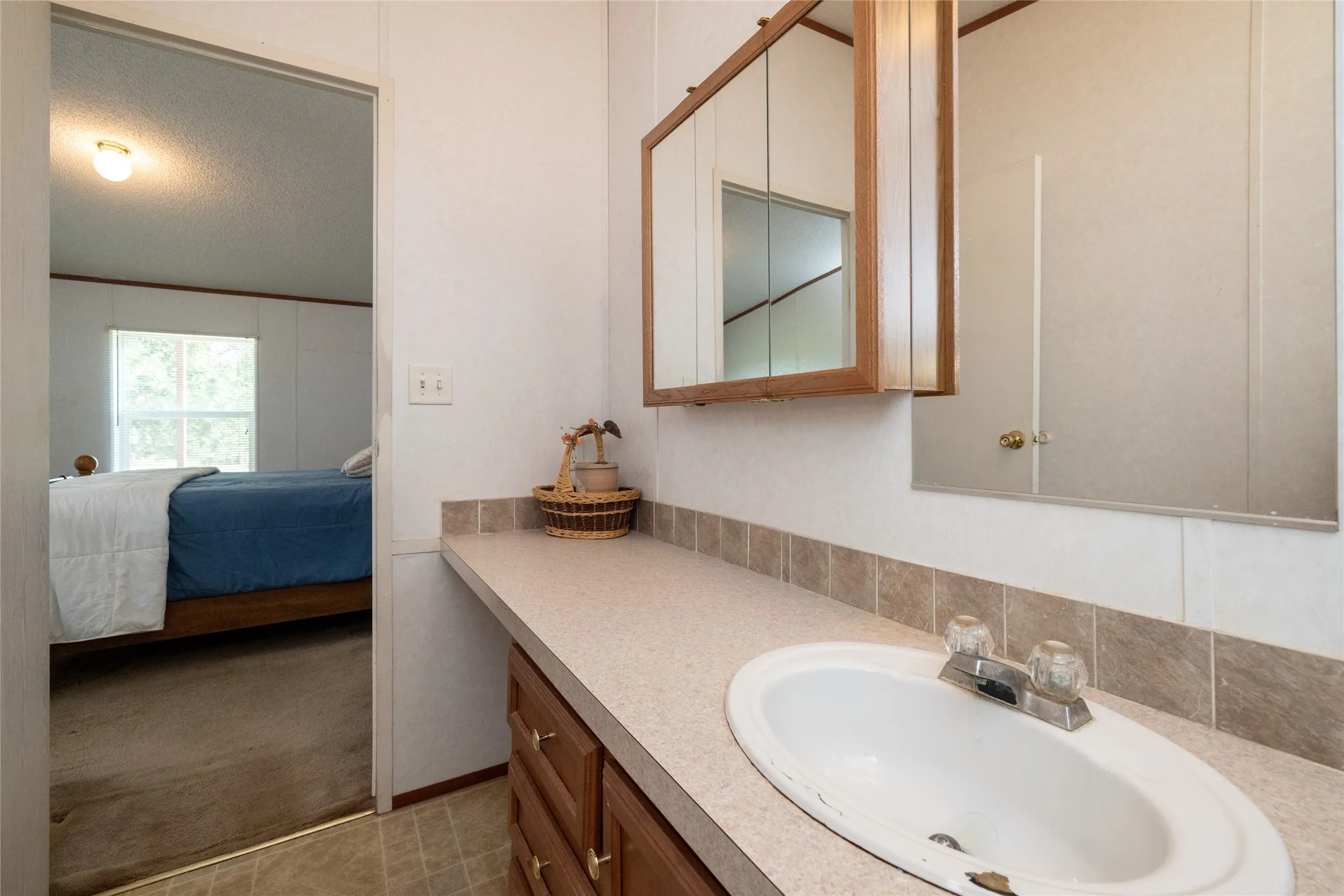 Bathroom featuring a textured ceiling and vanity