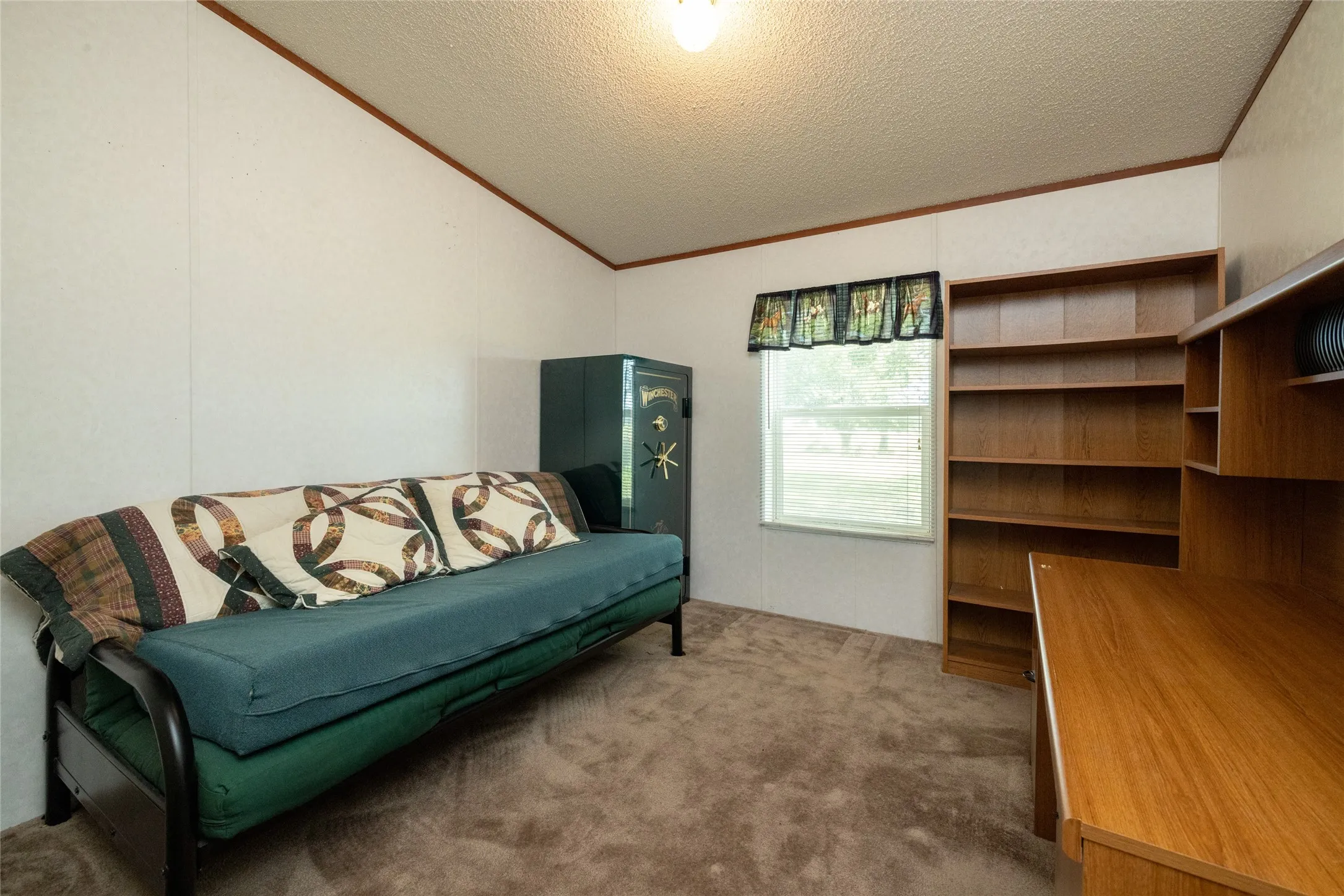 Sitting room featuring a textured ceiling, carpet flooring, and crown molding