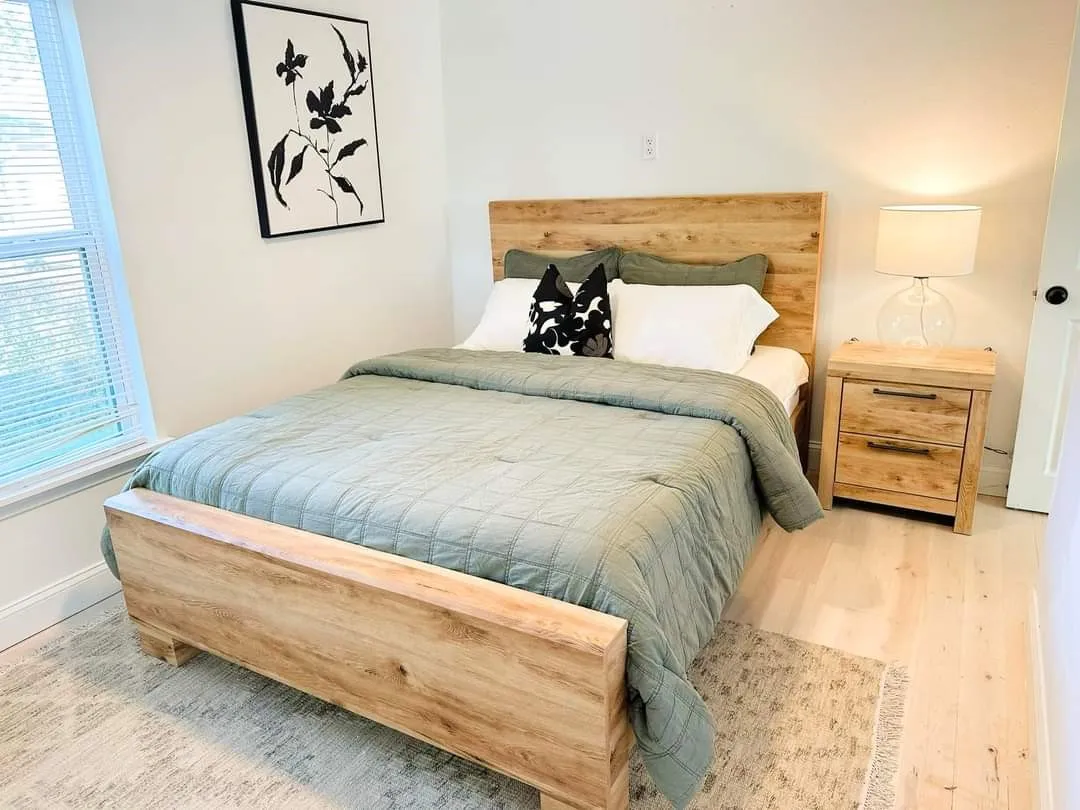 Bedroom featuring hardwood / wood-style floors and multiple windows