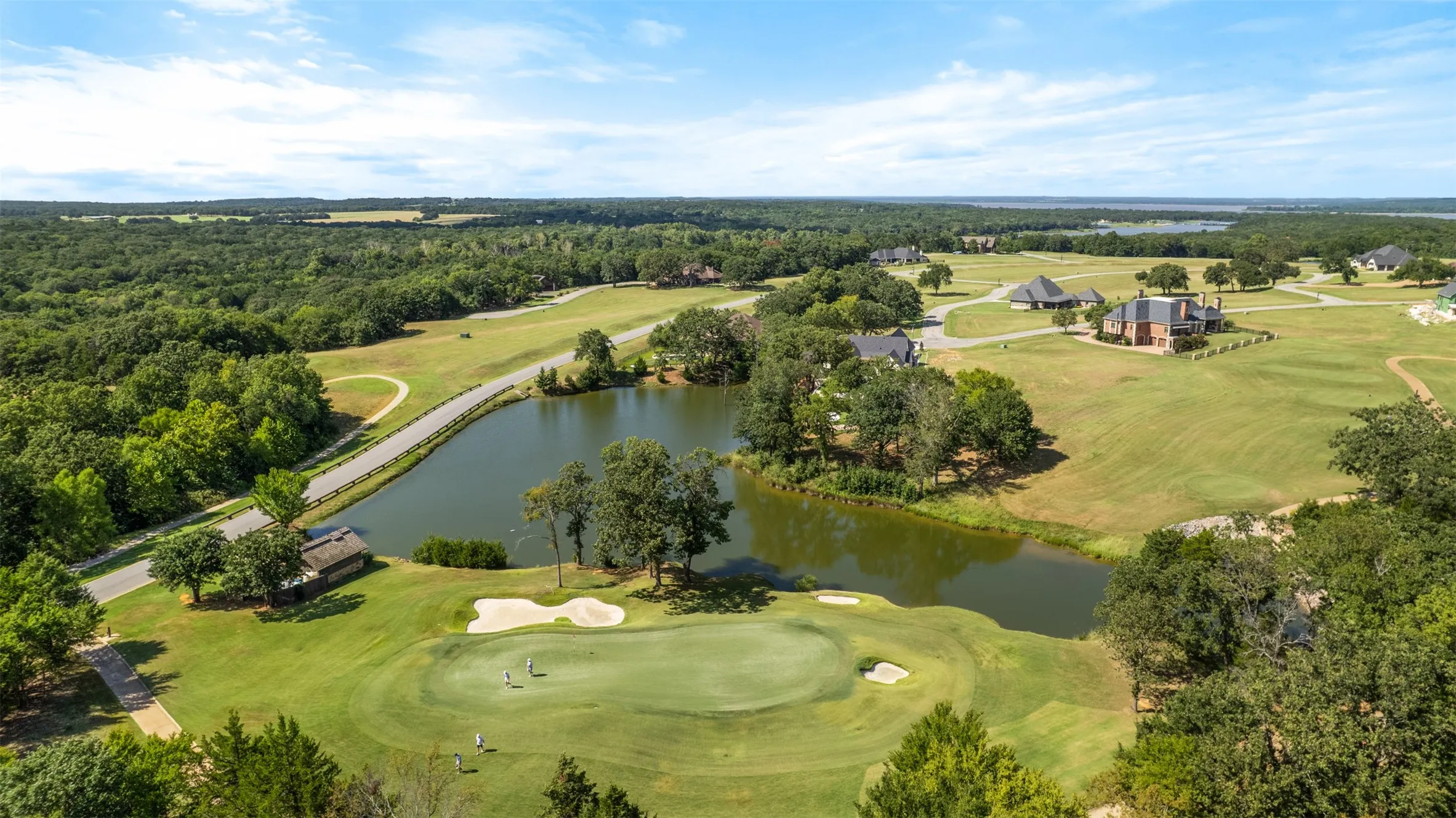 View of property location with a local golf course and a large body of water