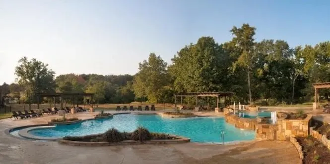 View of community pool featuring a pergola and a patio area