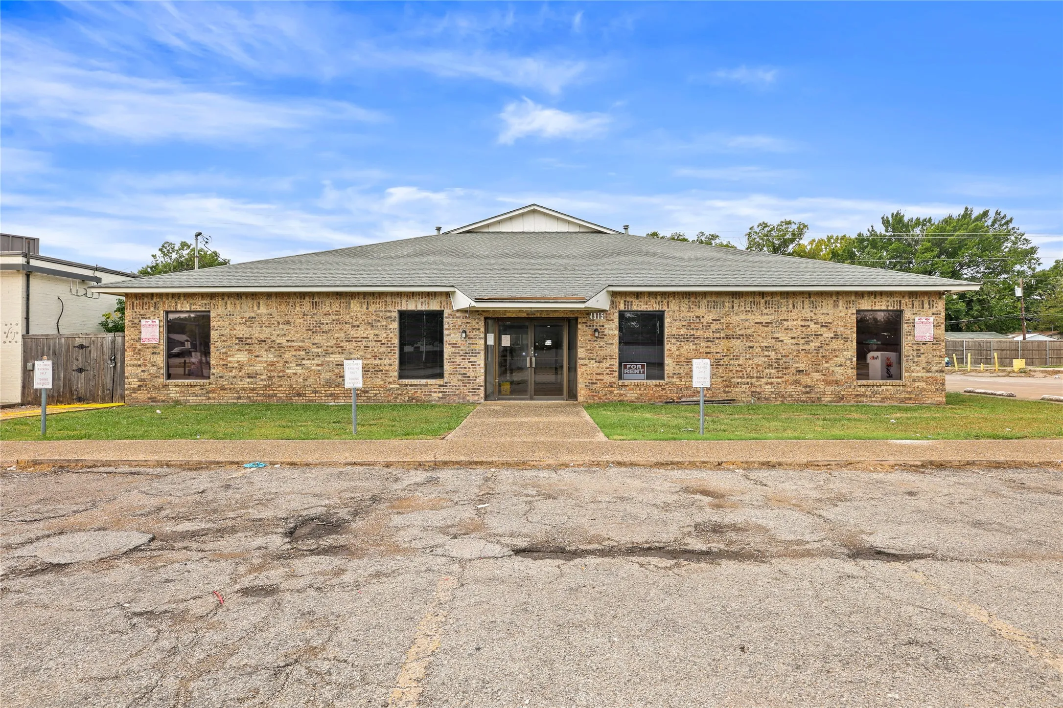 View of front facade with french doors and a front lawn