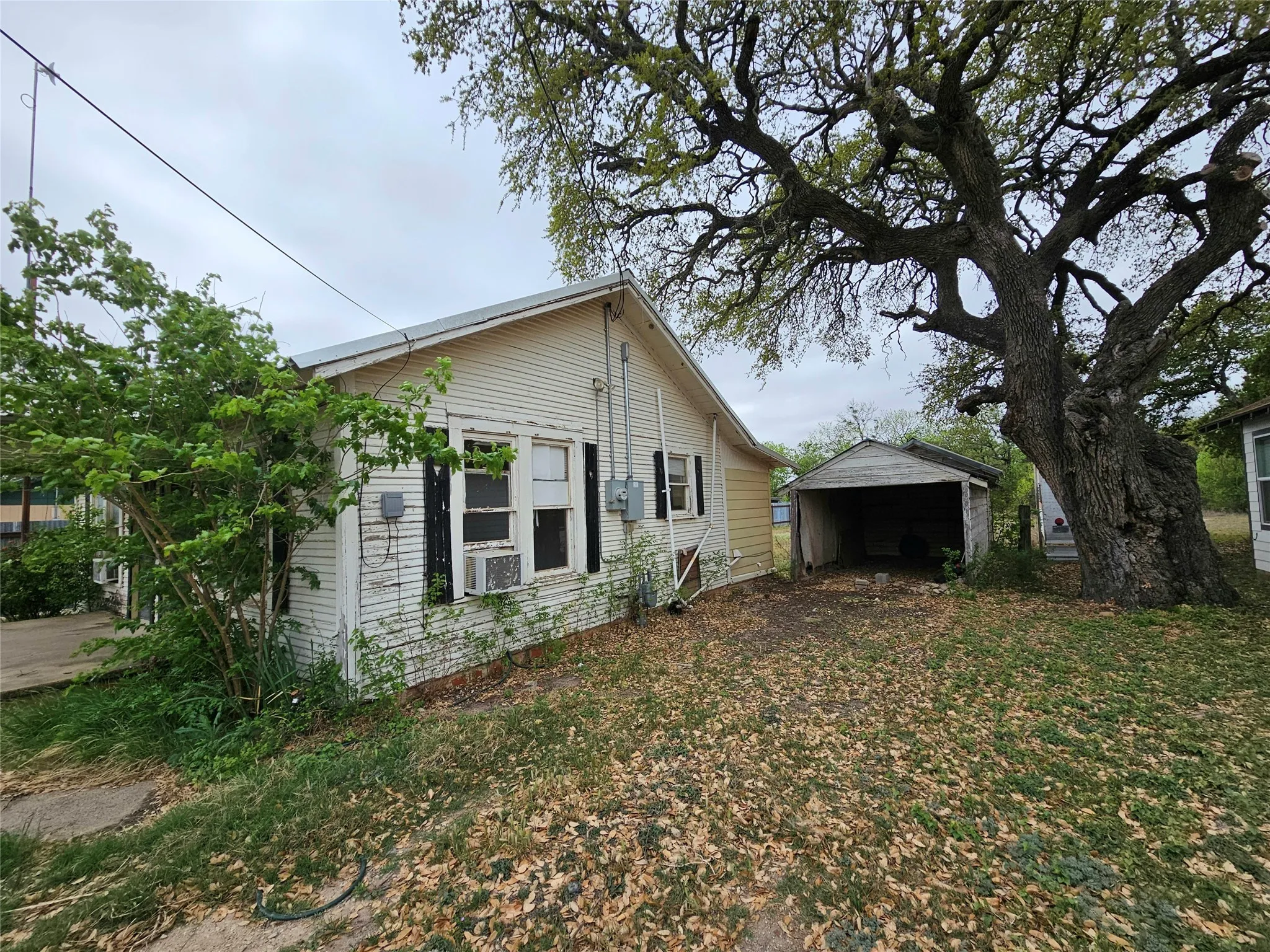 View of side of home featuring cooling unit
