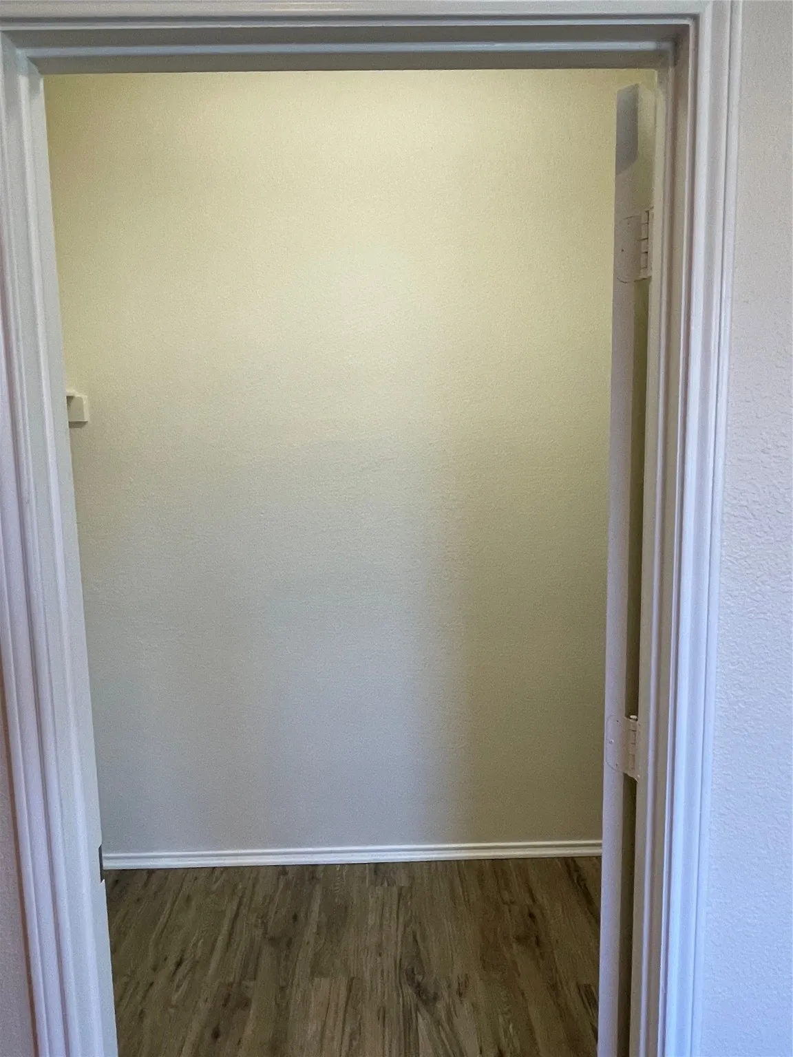 Hallway with dark hardwood / wood-style flooring
