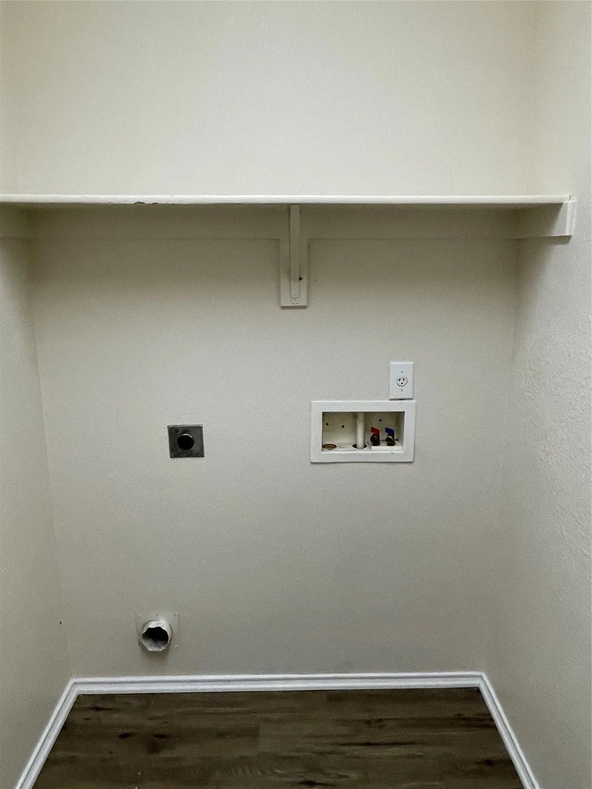 Laundry area featuring hookup for a washing machine, dark hardwood / wood-style flooring, and hookup for an electric dryer
