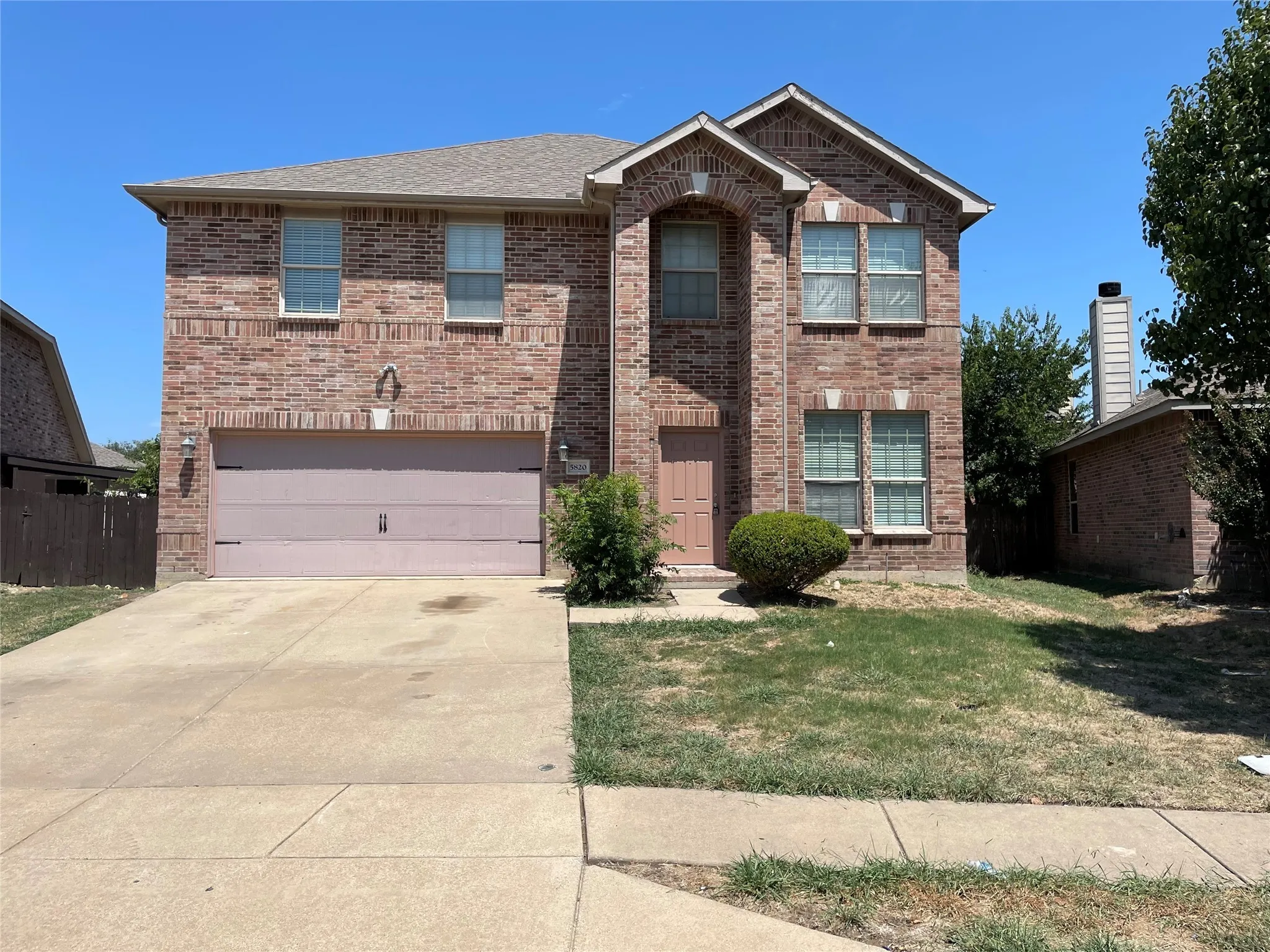 View of property featuring a garage and a front yard