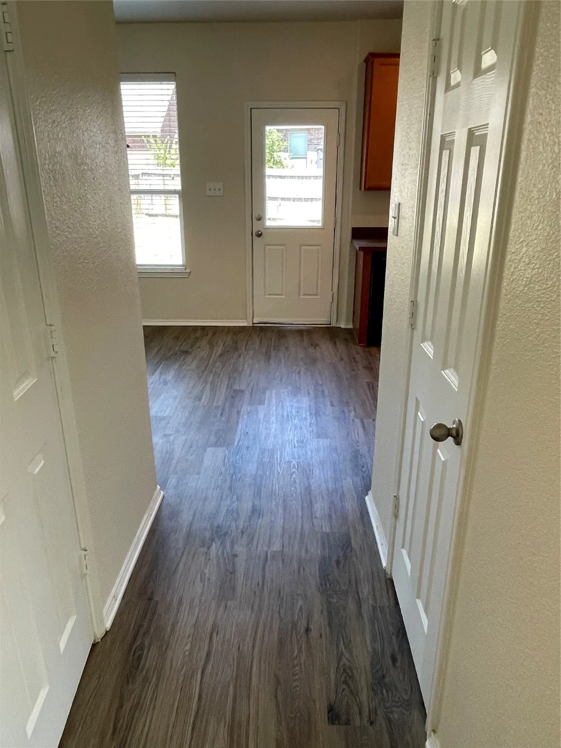 Hall with dark hardwood / wood-style flooring