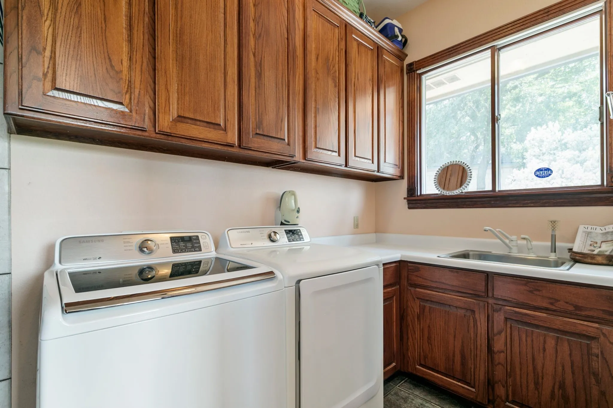 Washroom with cabinets, washer and clothes dryer, and sink