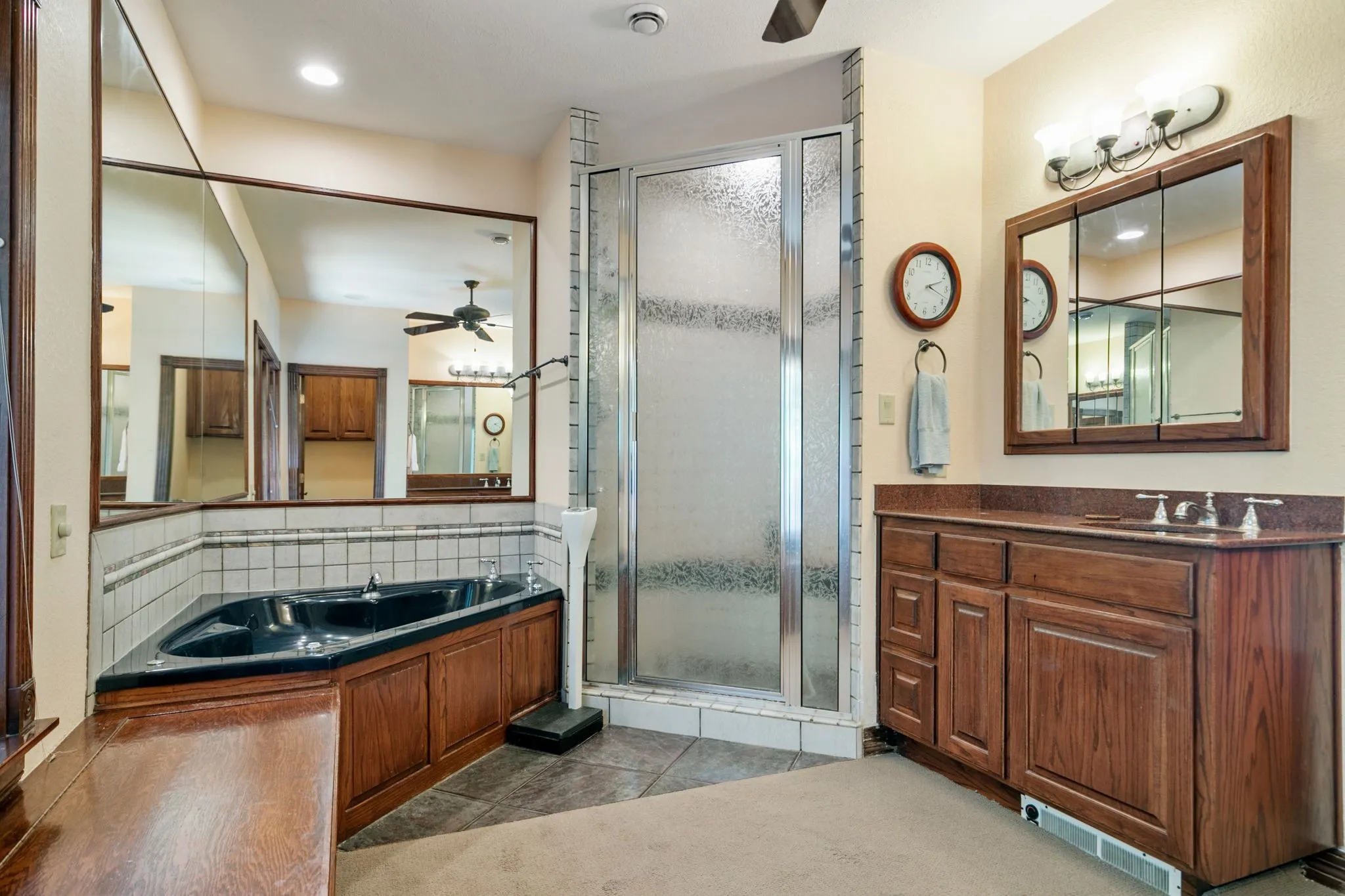 Bathroom featuring tile patterned floors, vanity, tasteful backsplash, ceiling fan, and shower with separate bathtub
