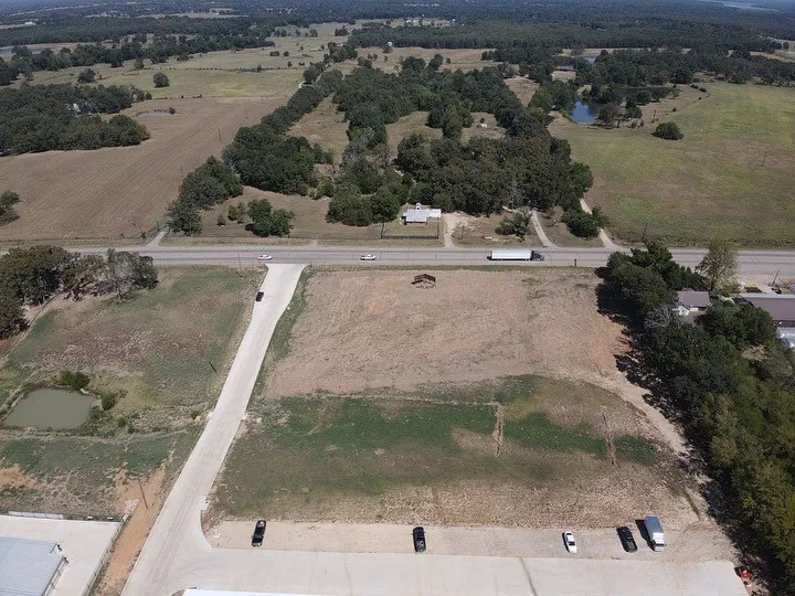 Birds eye view of property featuring a water view and a rural view
