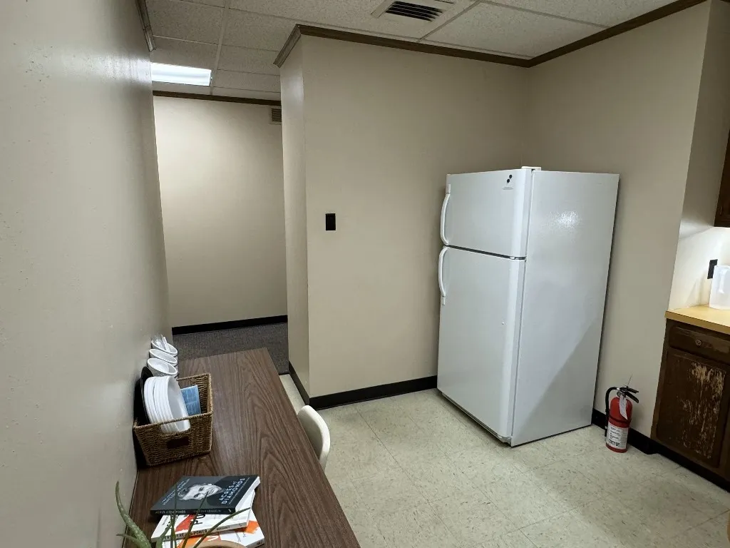 Kitchen featuring white refrigerator and a paneled ceiling