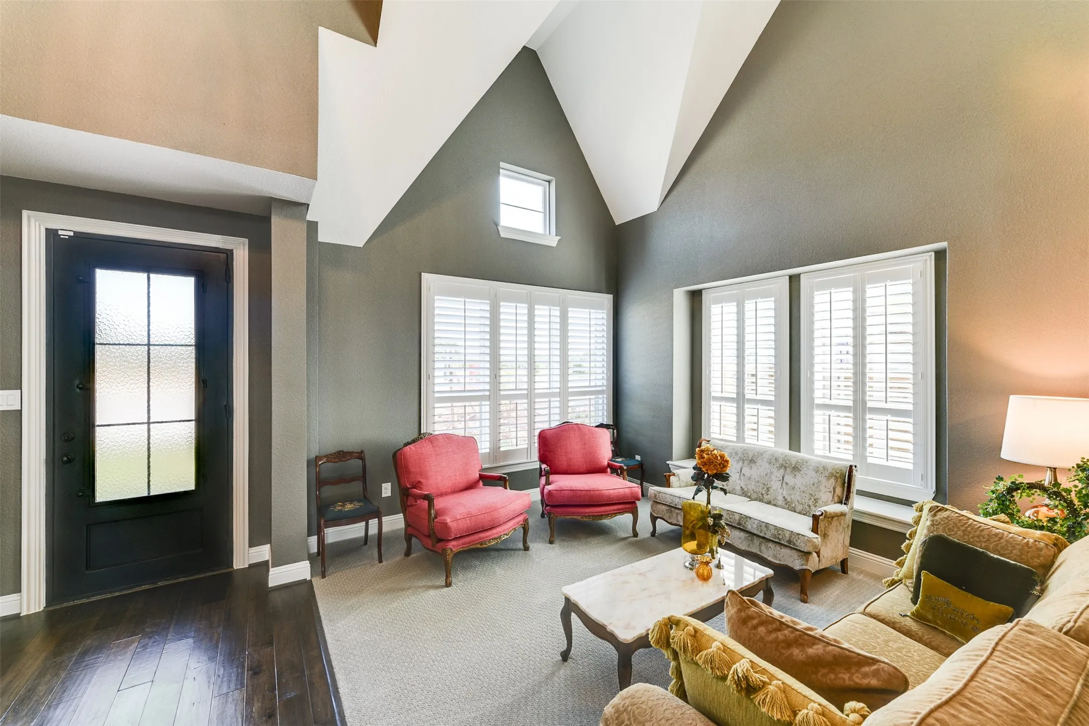 Living room featuring high vaulted ceiling