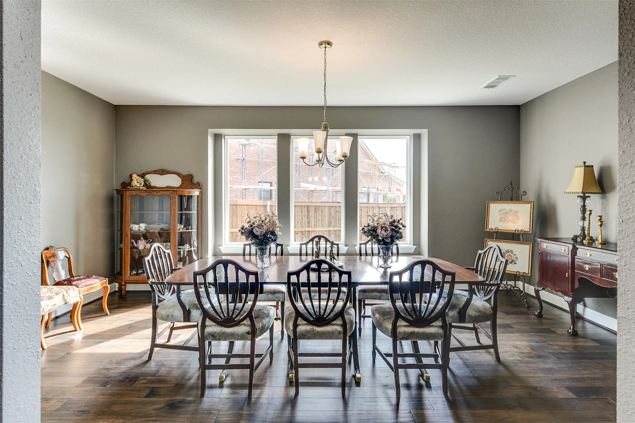 Formal dining area with a chandelier, a textured ceiling, and dark hardwood / wood-style flooring