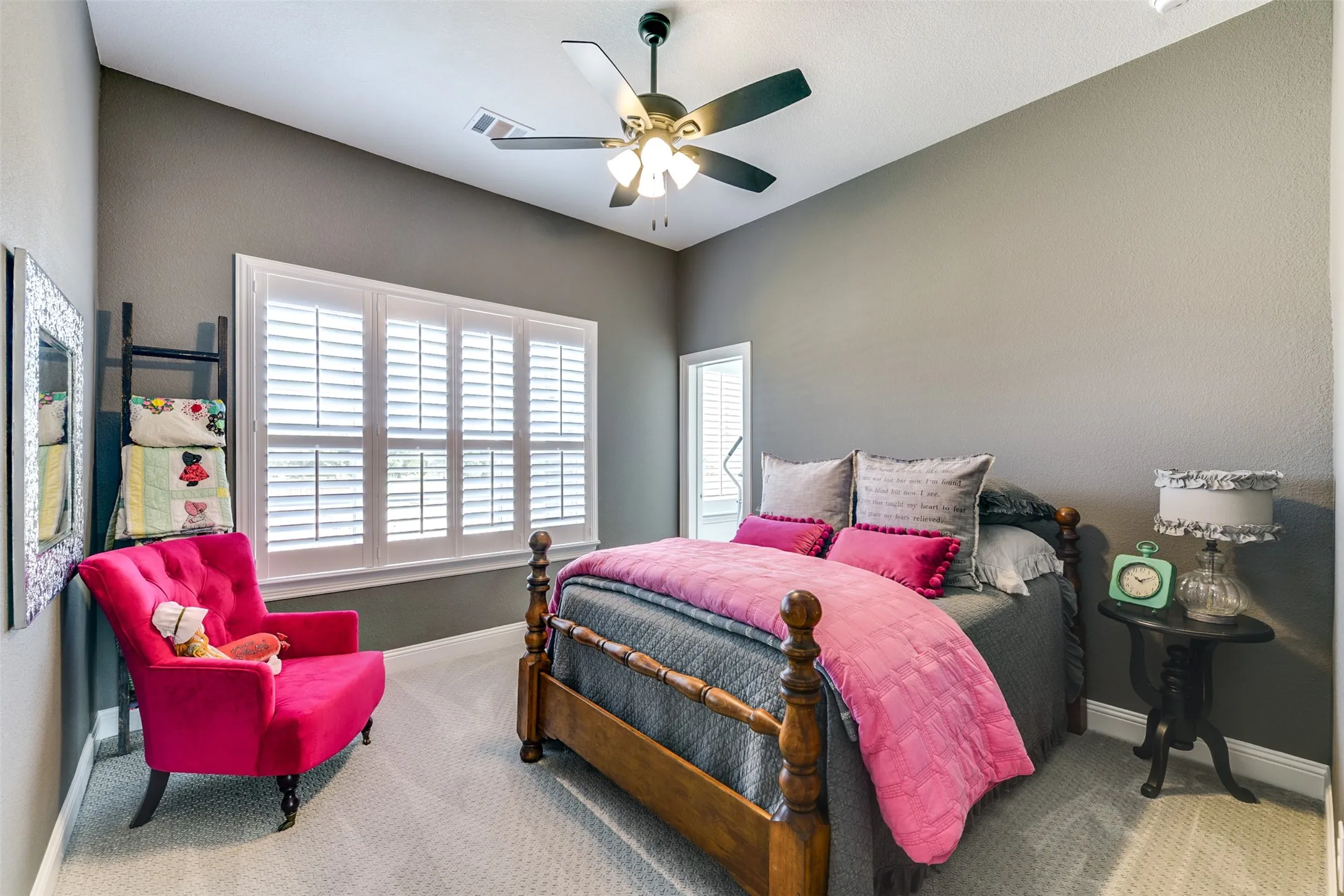 Second carpeted bedroom upstairs featuring ceiling fan