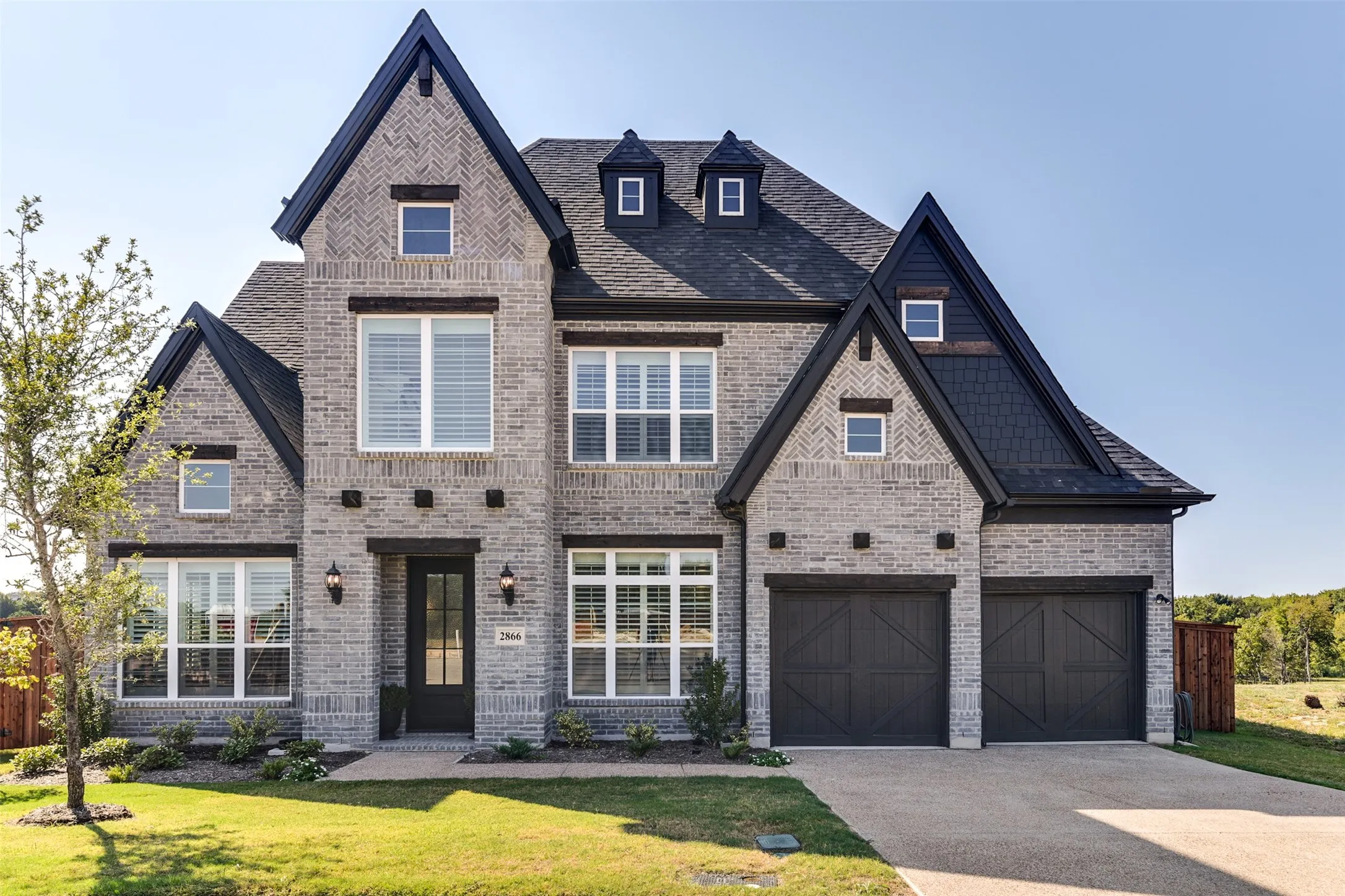 View of front of property with a front yard and a garage