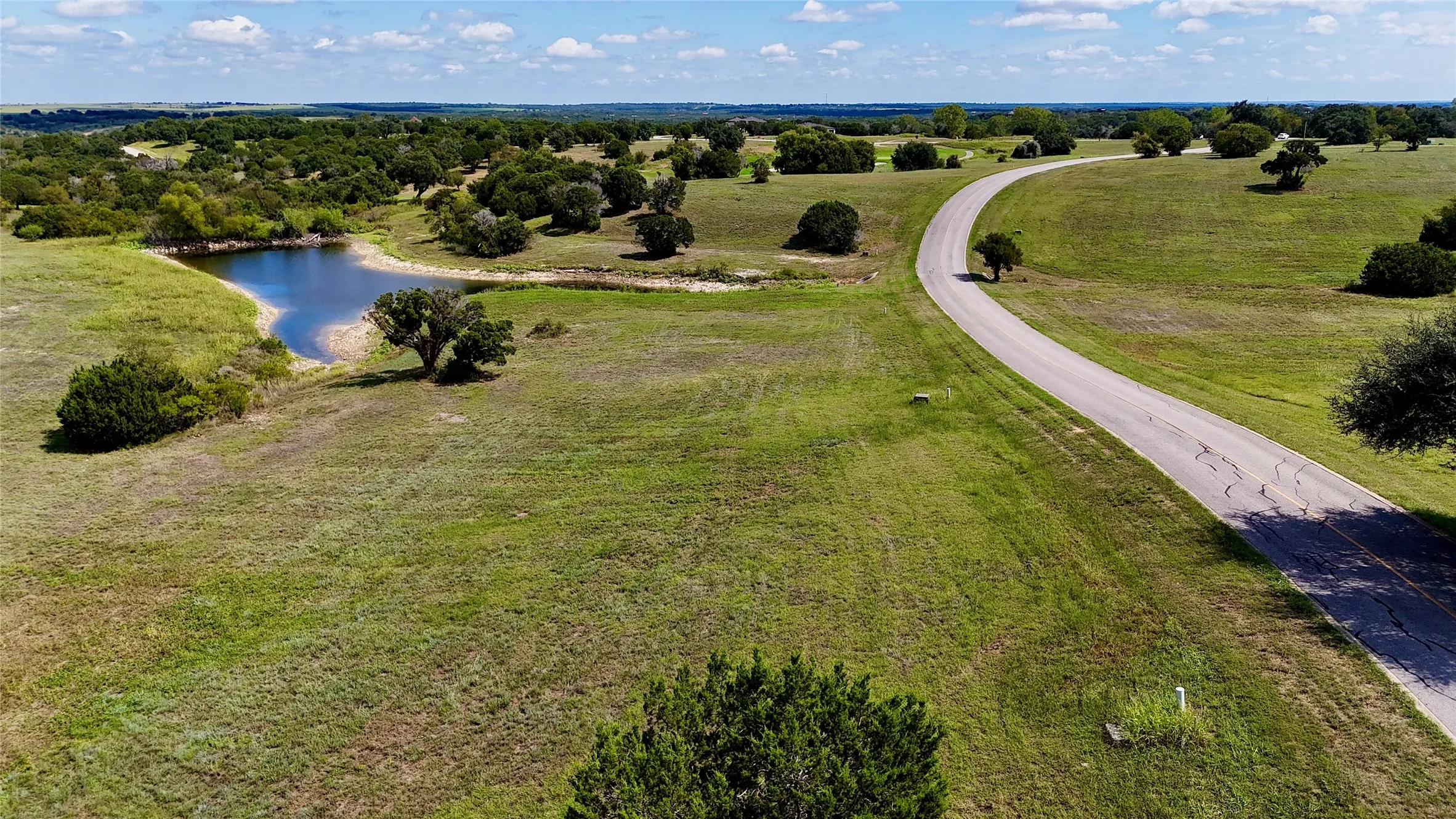 Drone / aerial view with a water view and a rural view