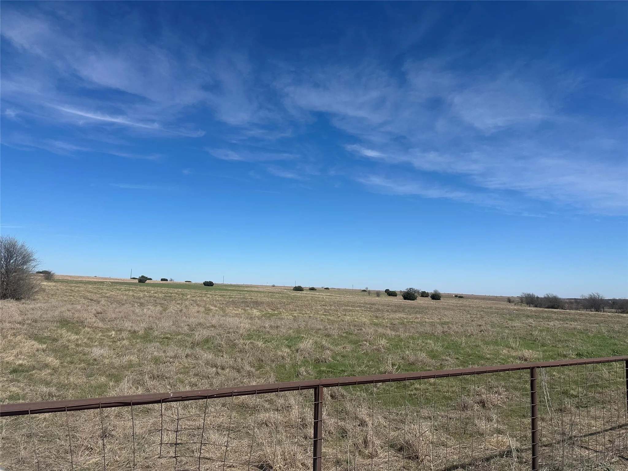 View of yard with a rural view and fence
