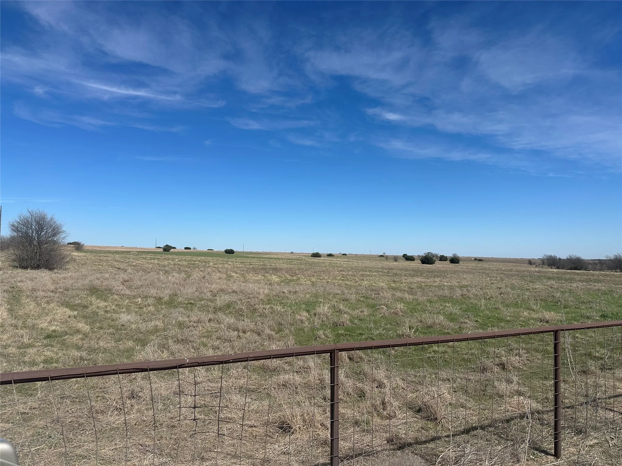 View of yard with a rural view and fence