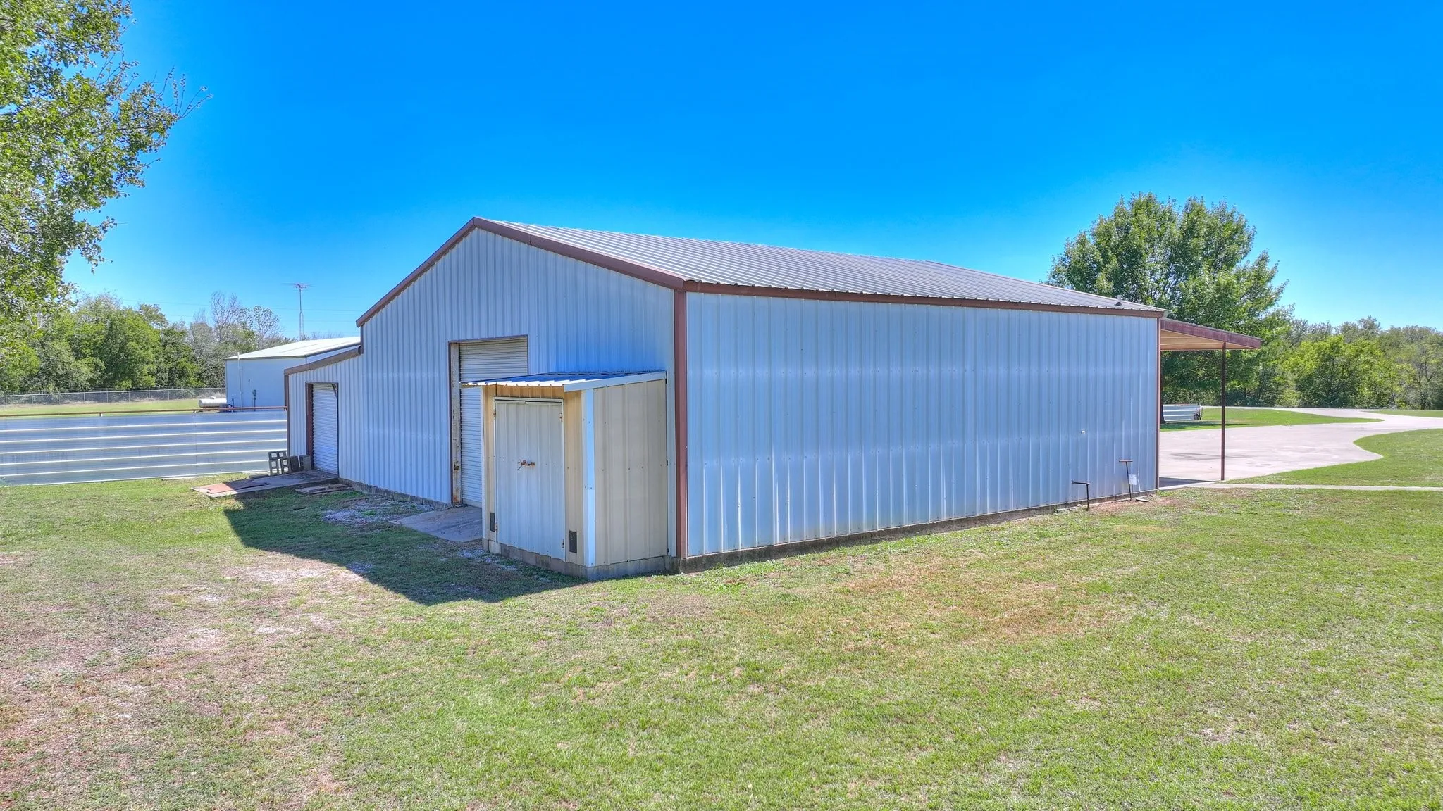 View of outdoor structure with a yard